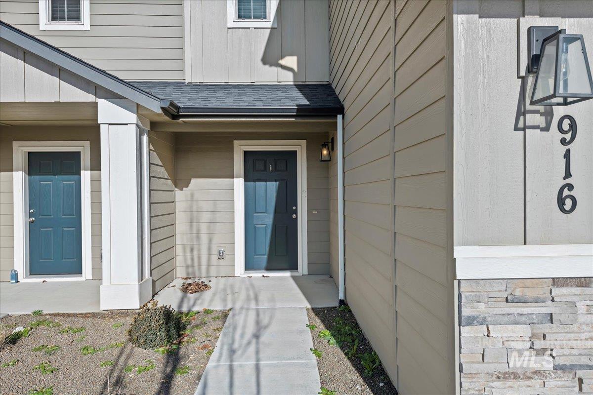 Property entrance with roof with shingles