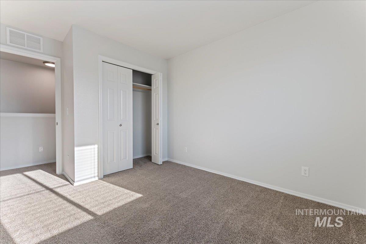 Unfurnished bedroom with carpet floors and a closet