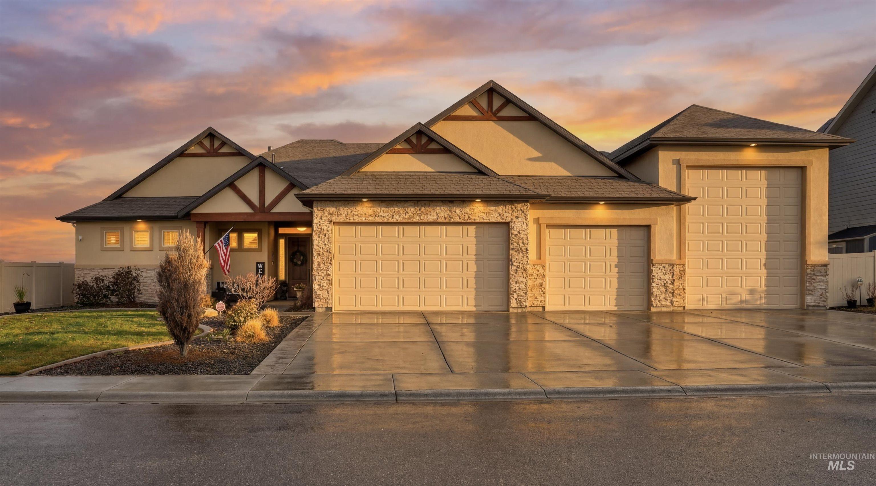 View of front facade with a garage, driveway, stucco siding, roof with shingles, and covered porch