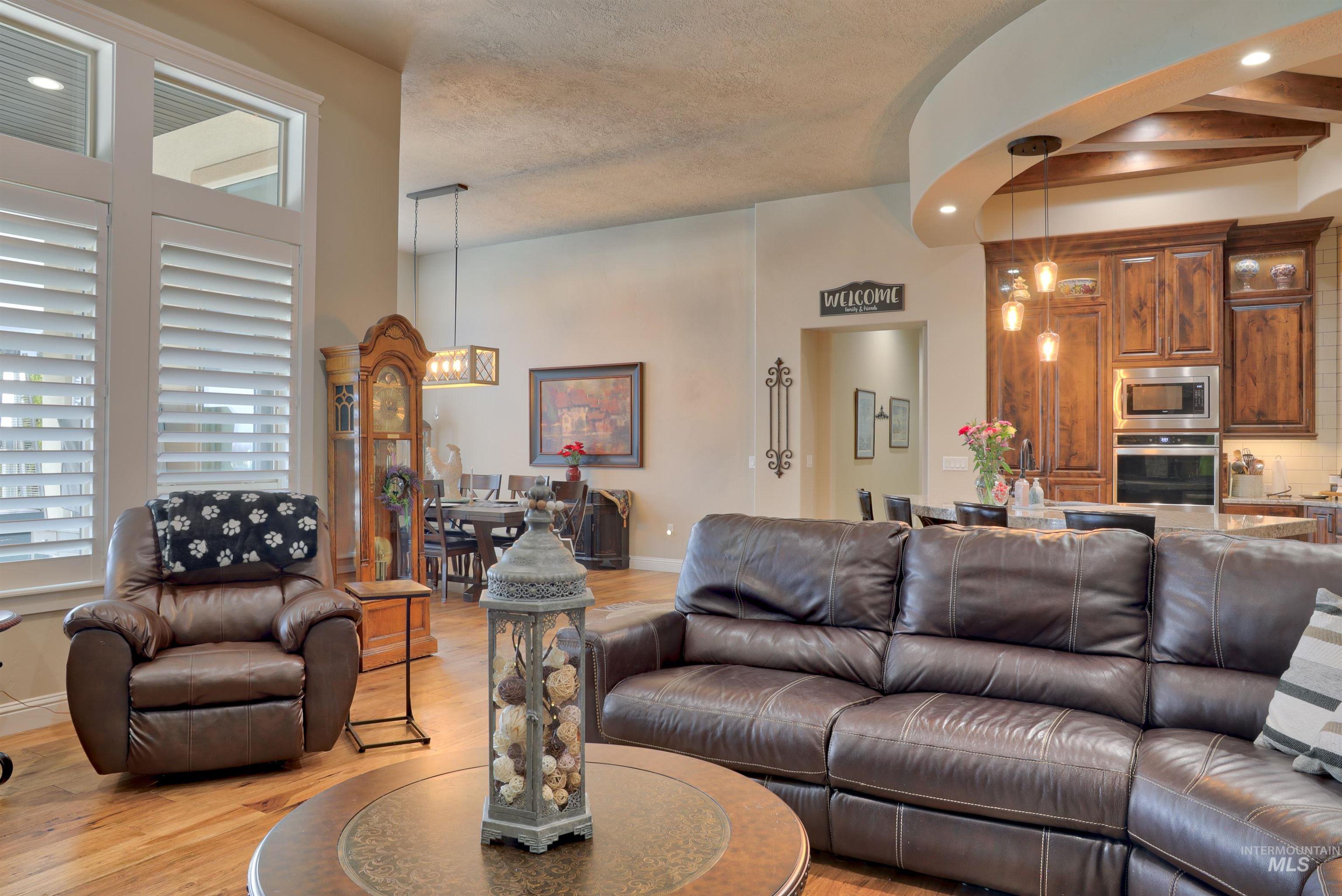 Living area featuring light wood-style floors, recessed lighting, and a textured ceiling