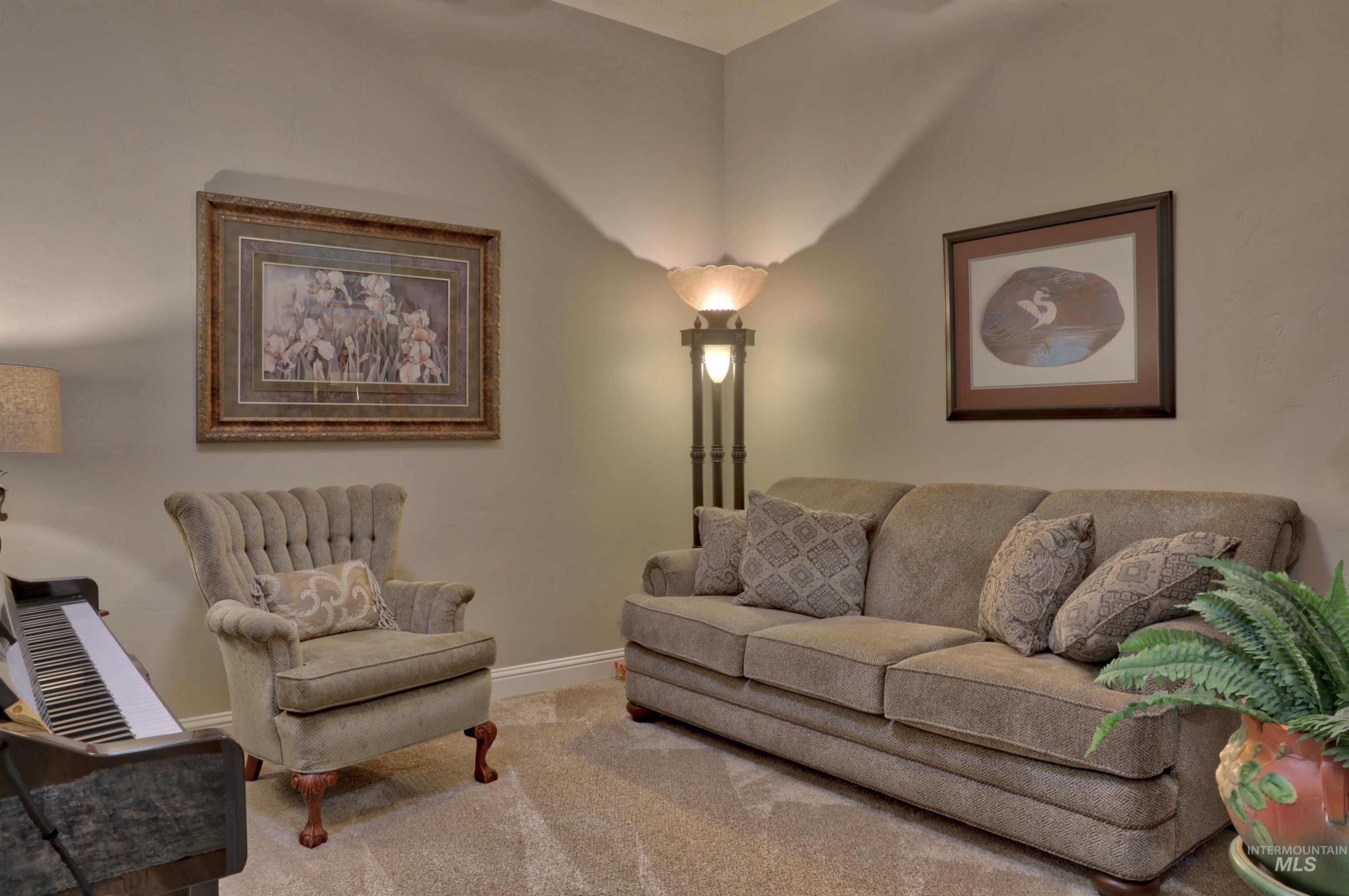 Living area featuring carpet and baseboards