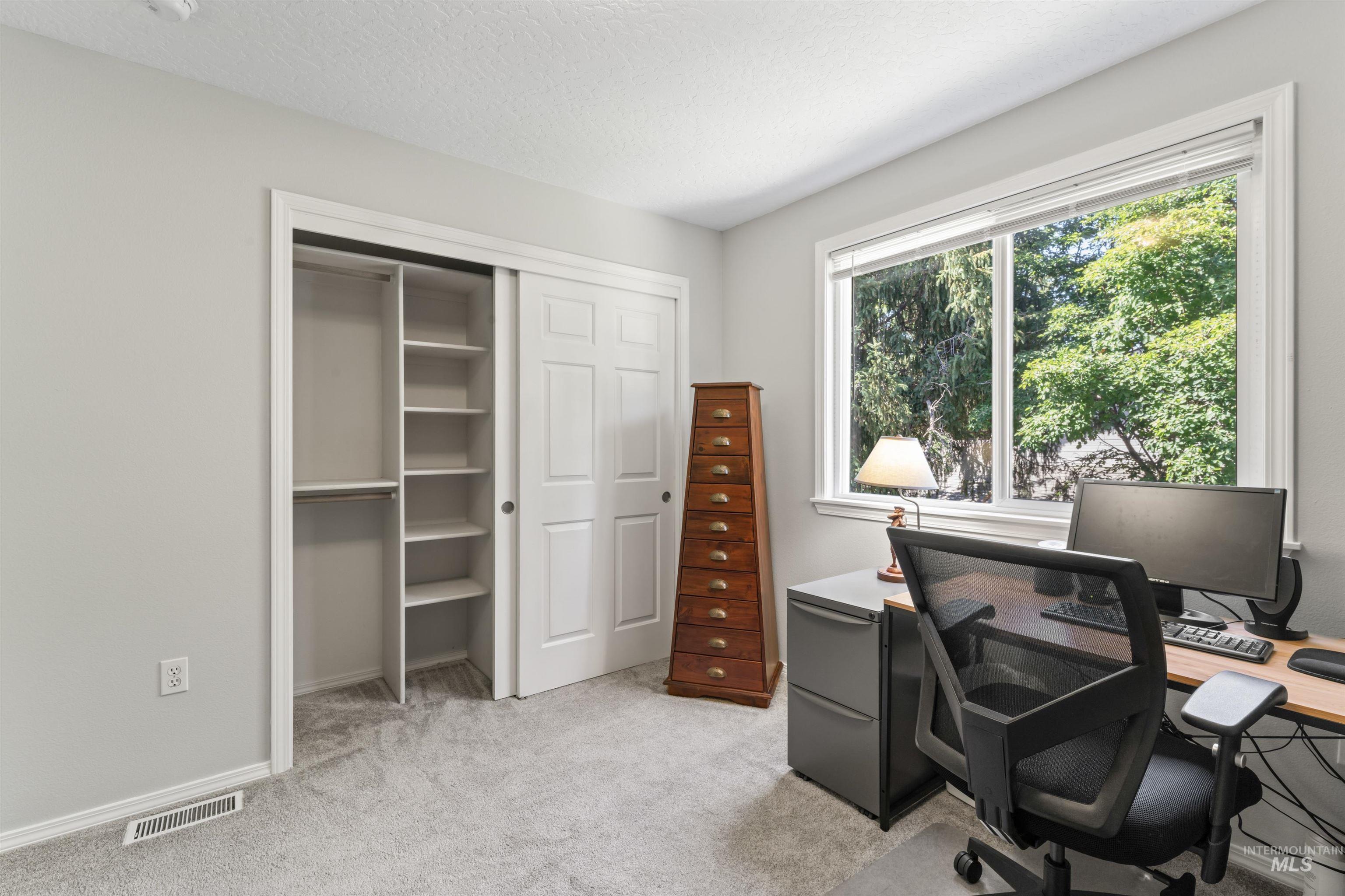 Office featuring light carpet and baseboards