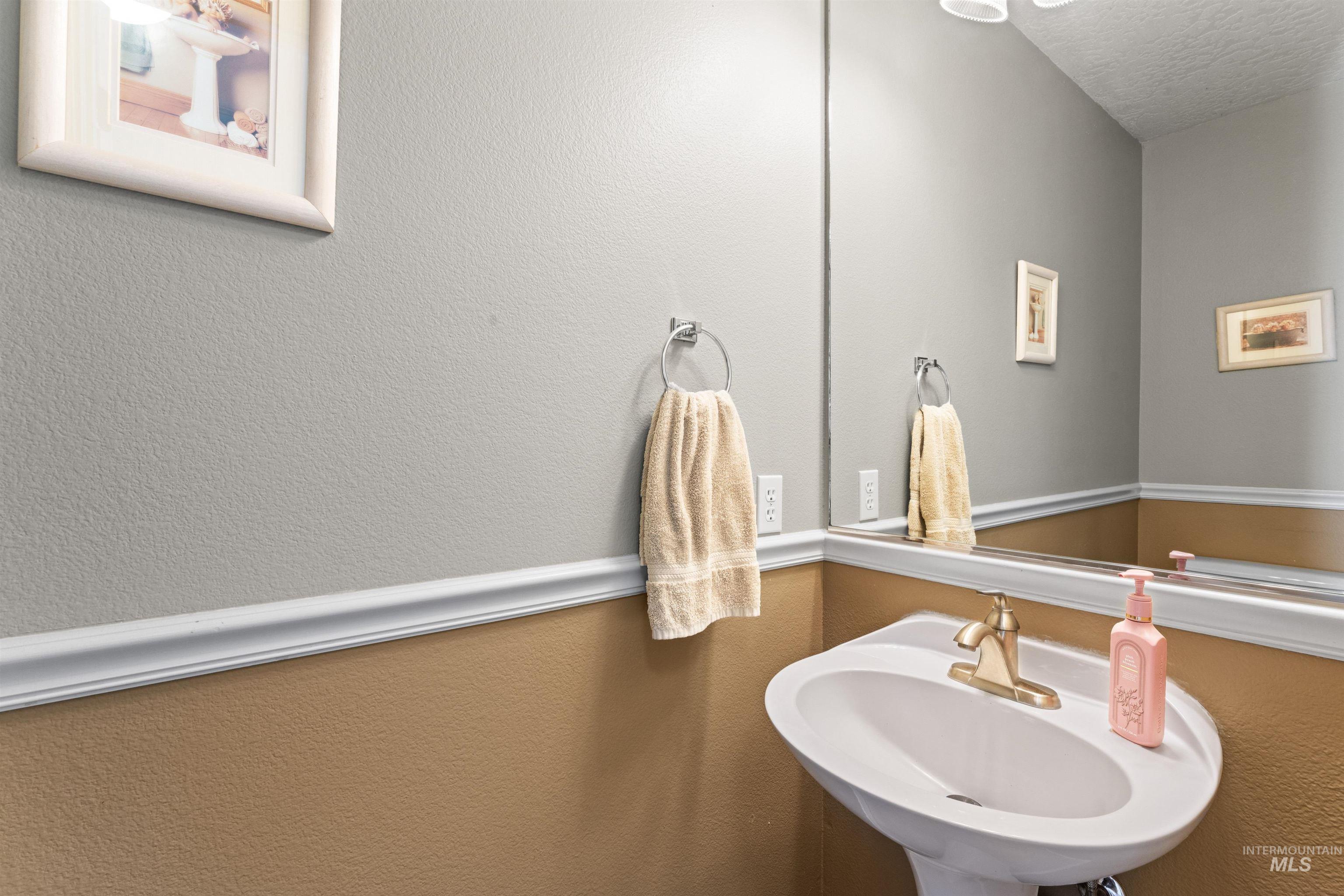 Bathroom with a sink and a textured ceiling