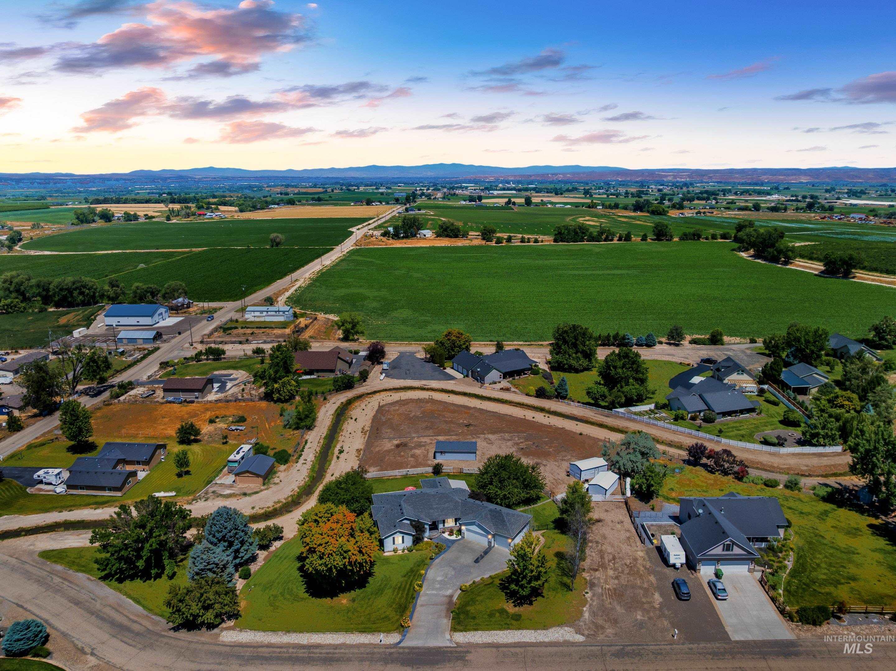 Aerial view at dusk of a view of rural / pastoral area, a mountain view, and agricultural area