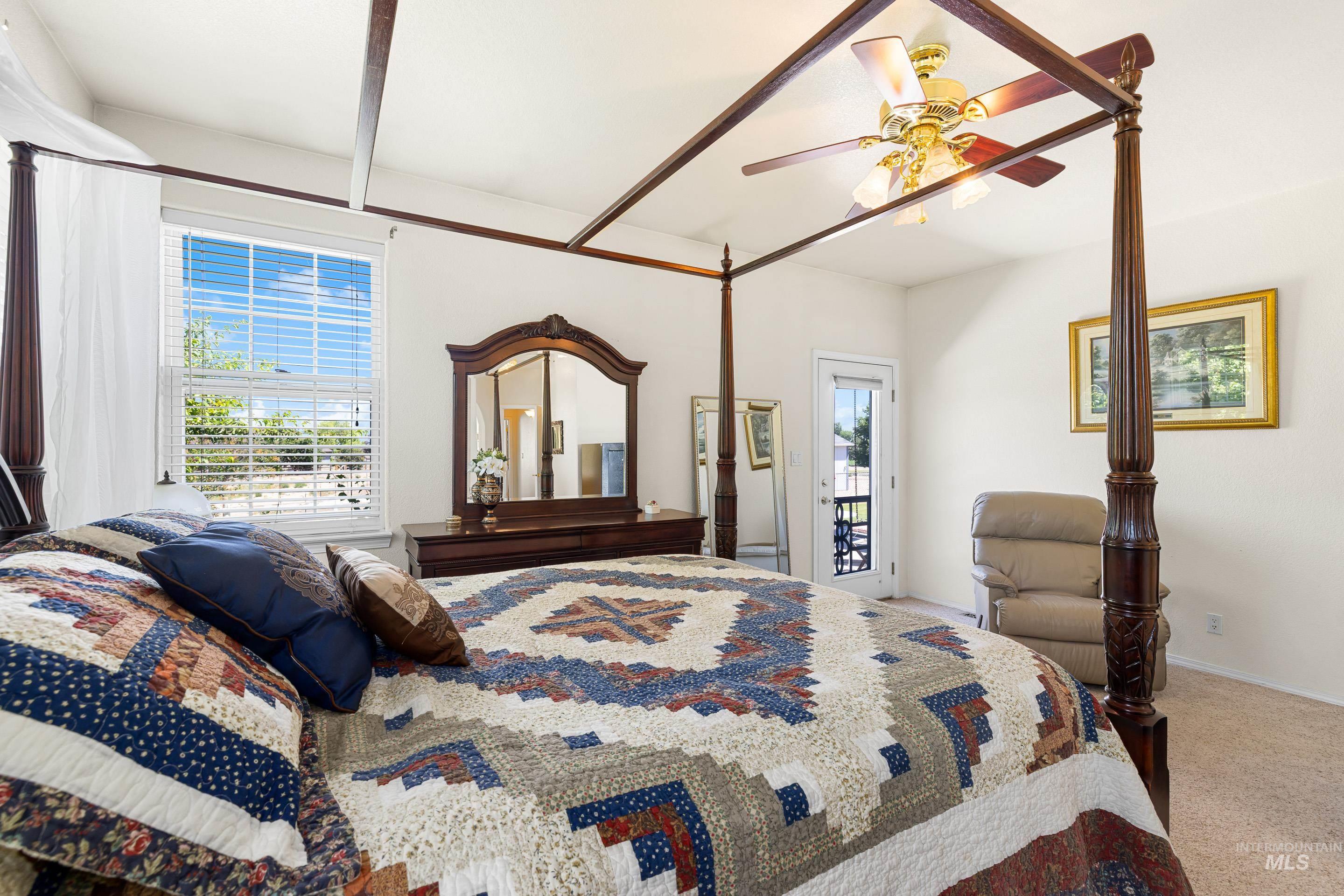Bedroom with light carpet and a ceiling fan