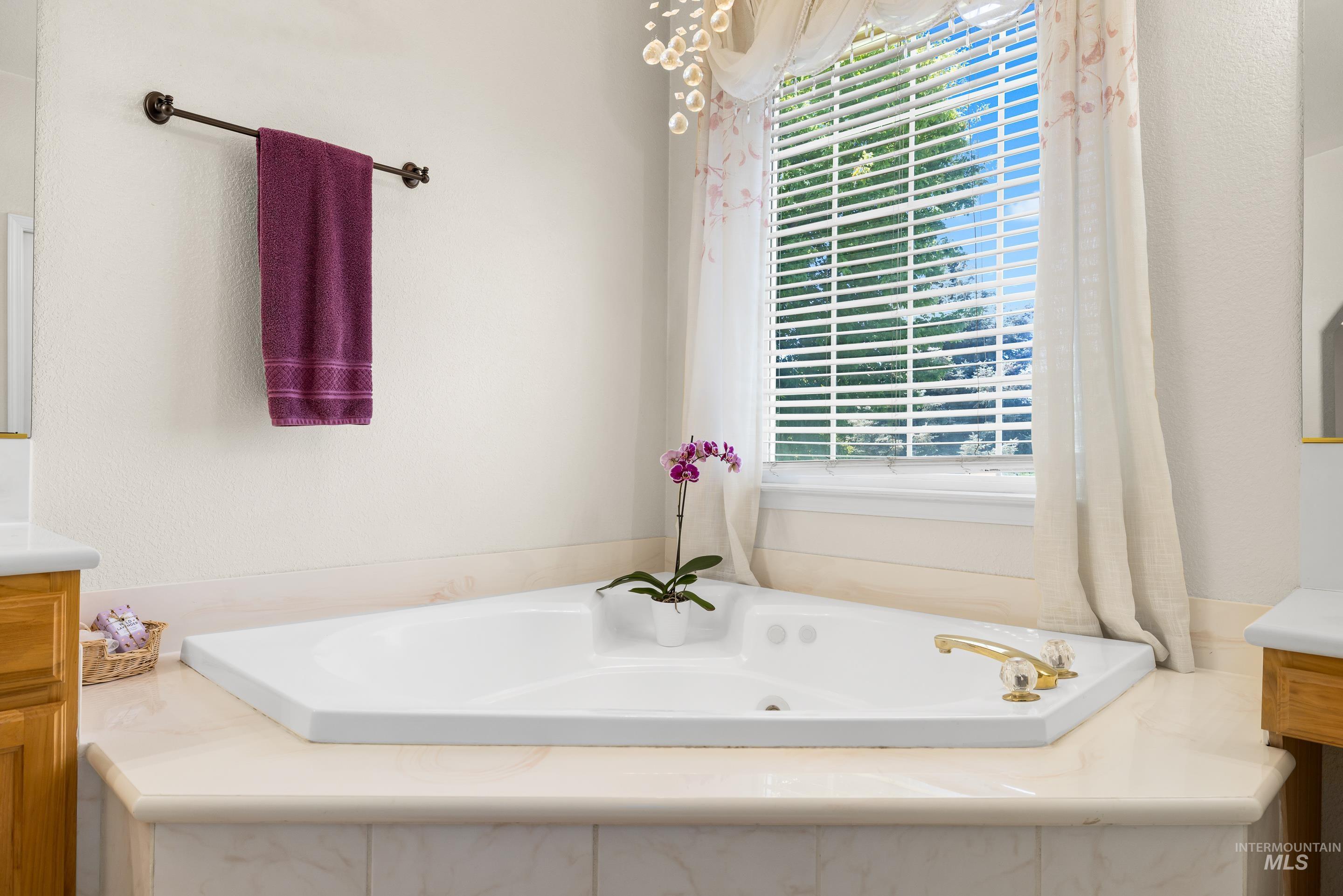 Full bathroom with vanity and a bath