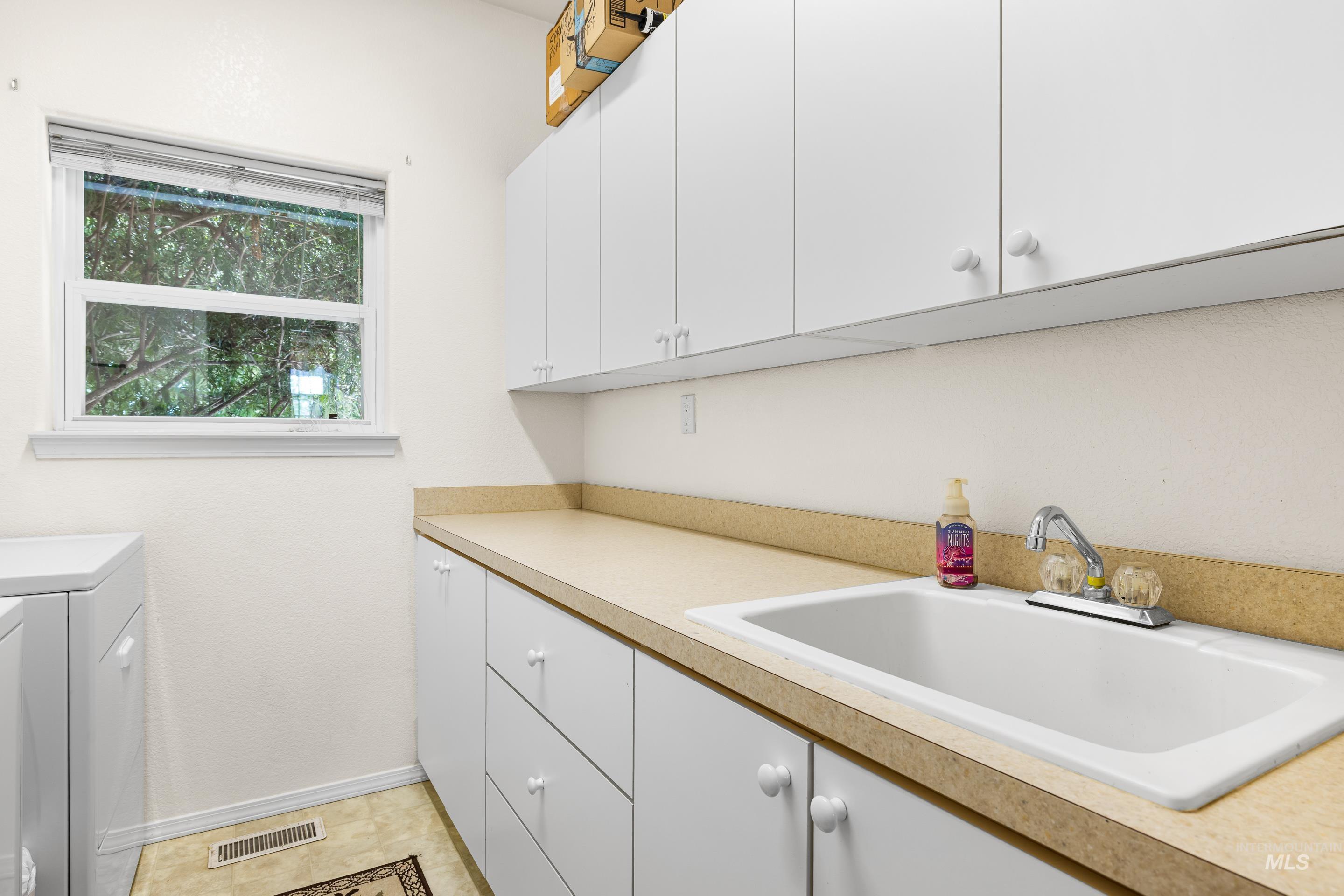 Laundry room featuring cabinet space and independent washer and dryer