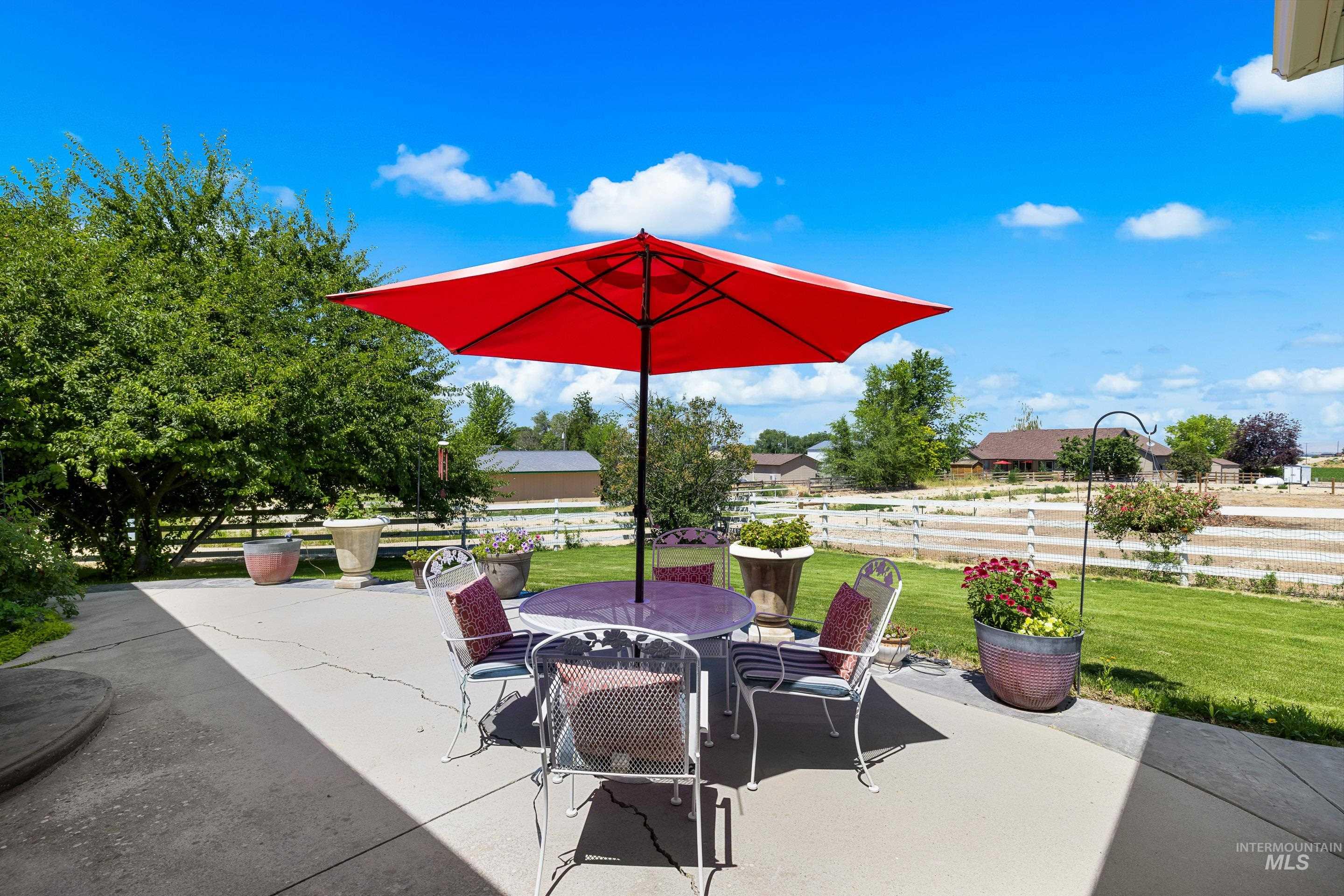 Fenced backyard with outdoor dining space and a patio
