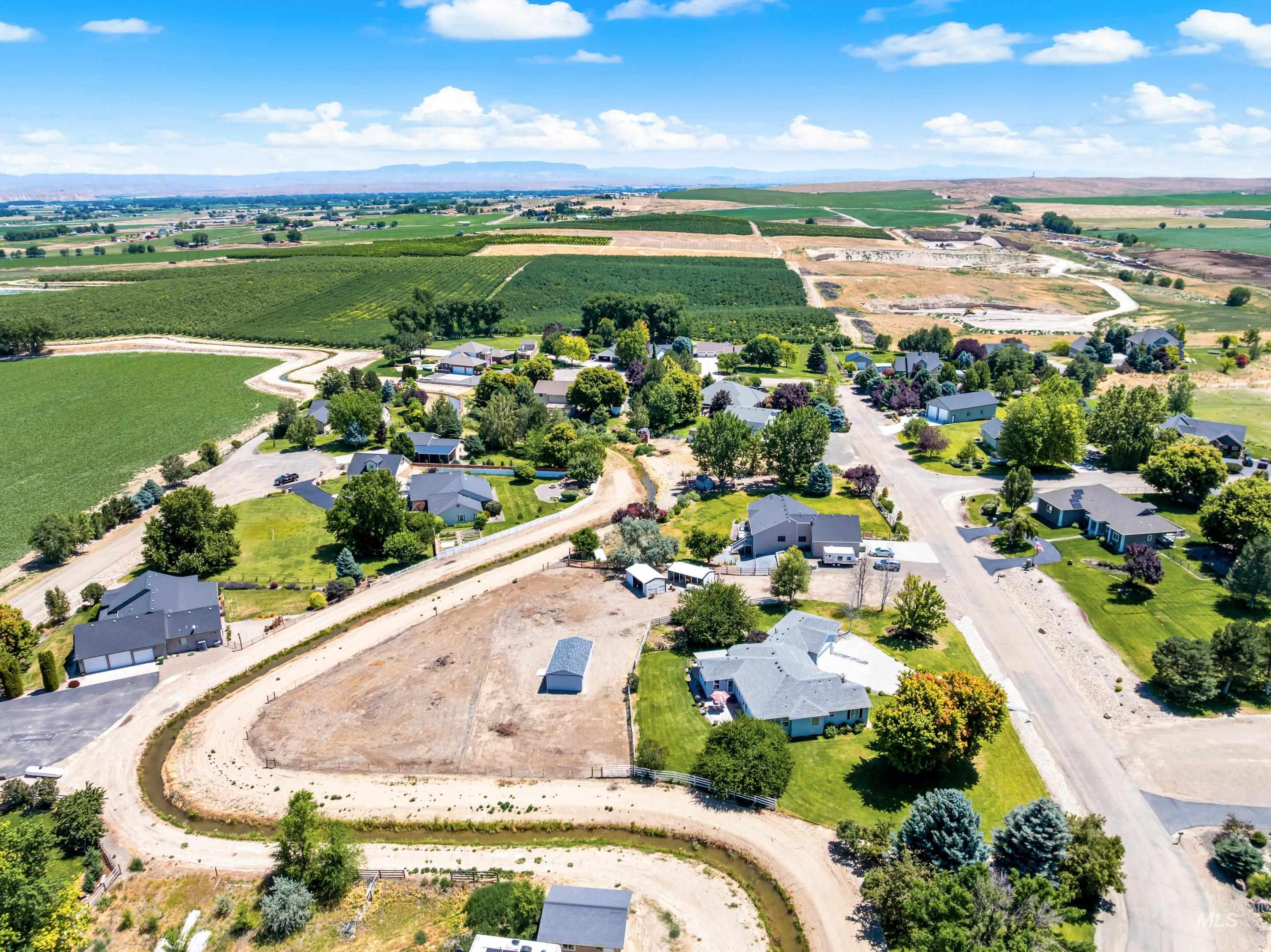 View of rural area with large plots for crops and a mountainous background