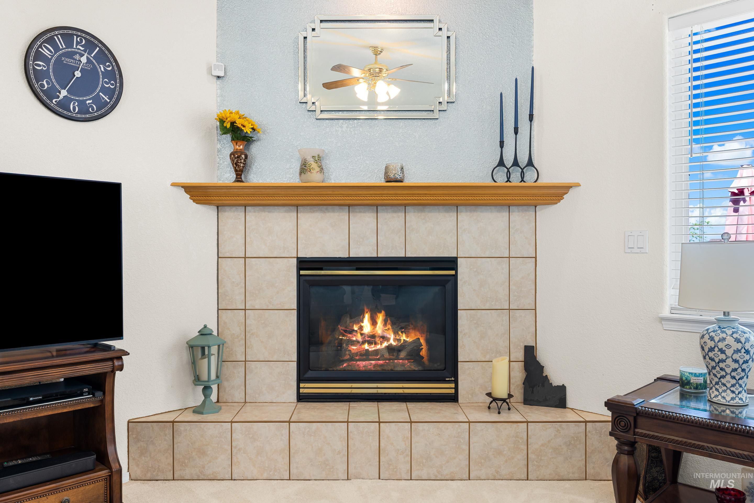 Detailed view of a fireplace and ceiling fan