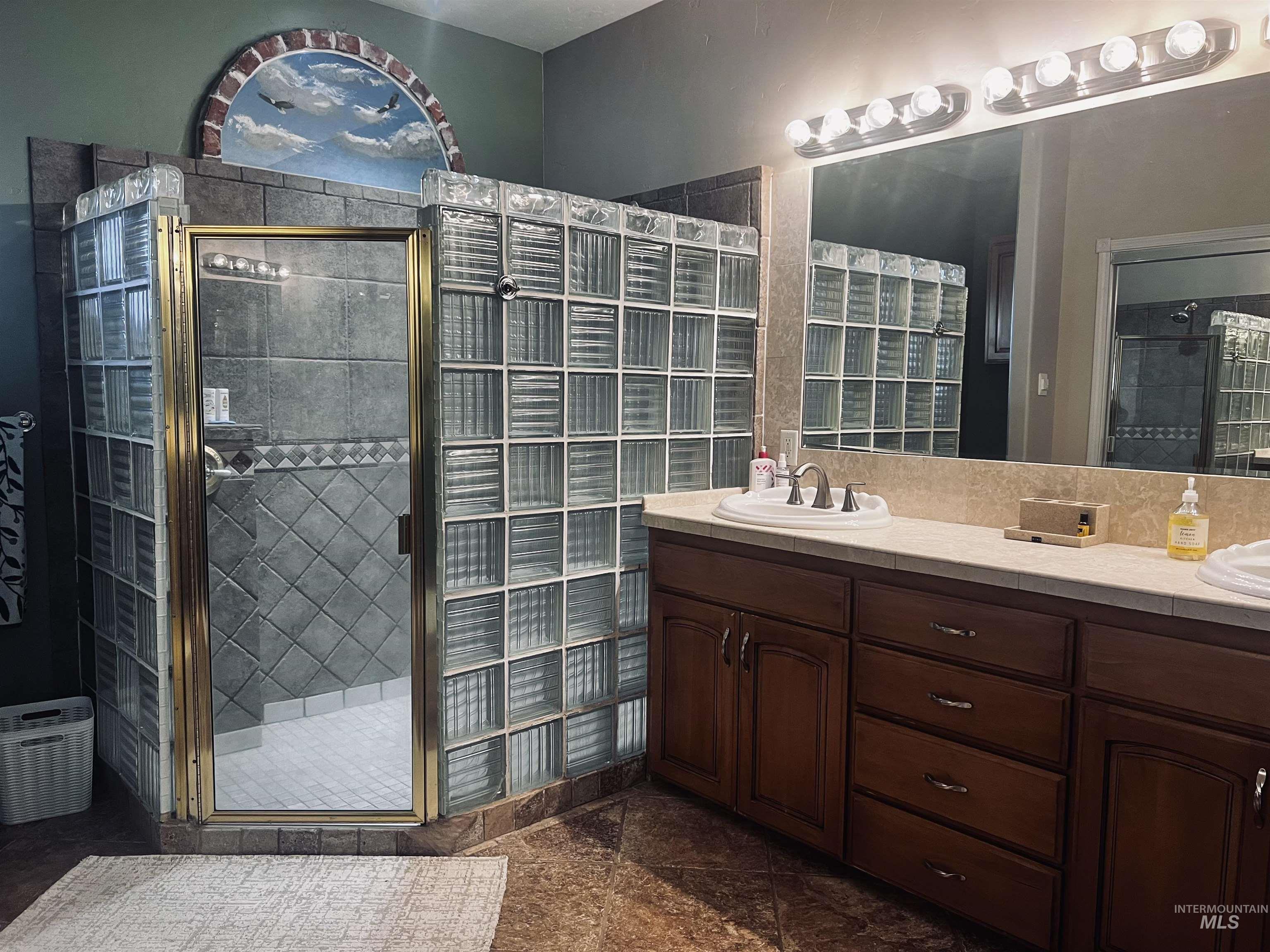 Bathroom with double vanity and a stall shower