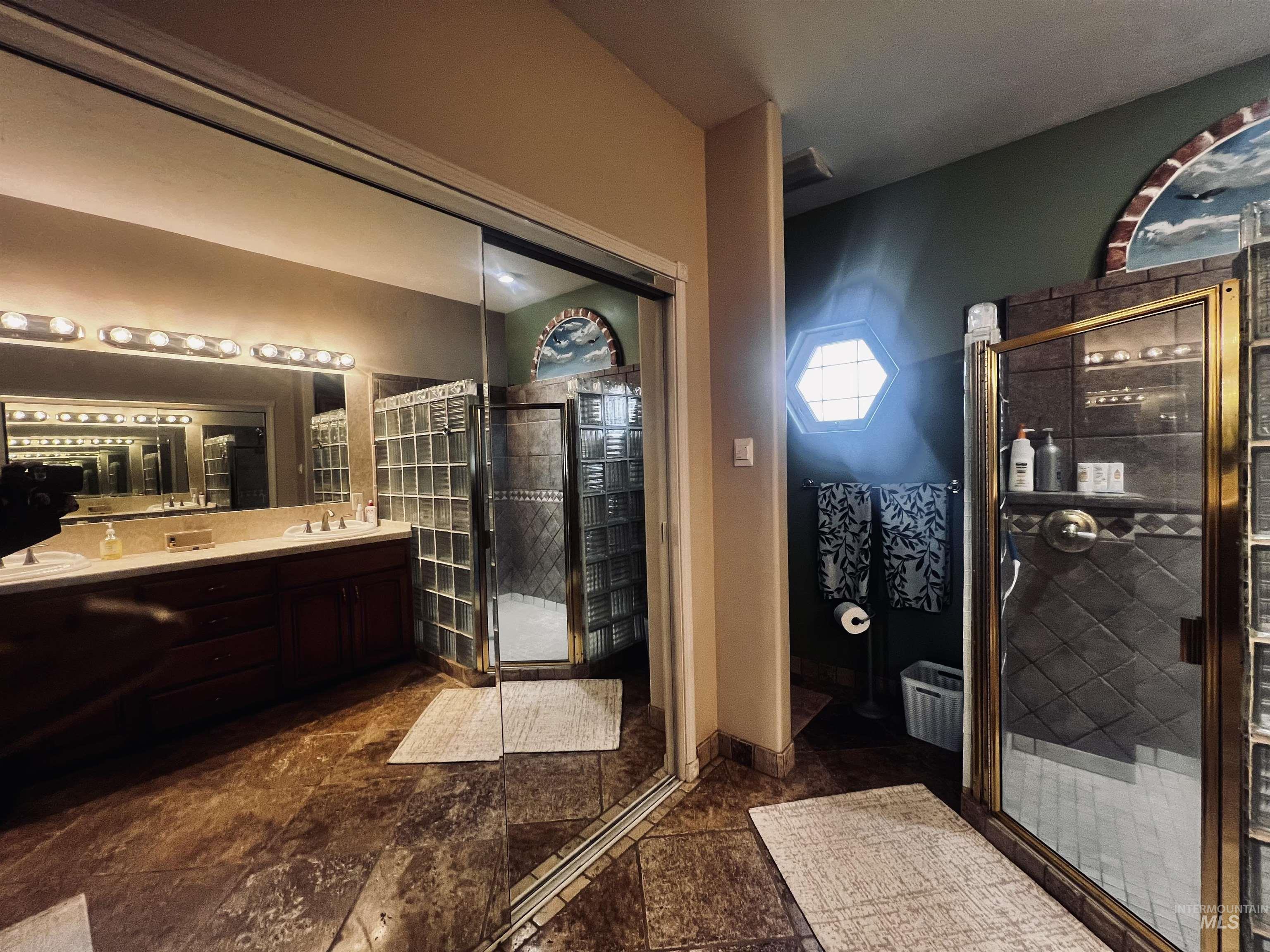 Full bath with a stall shower and double vanity