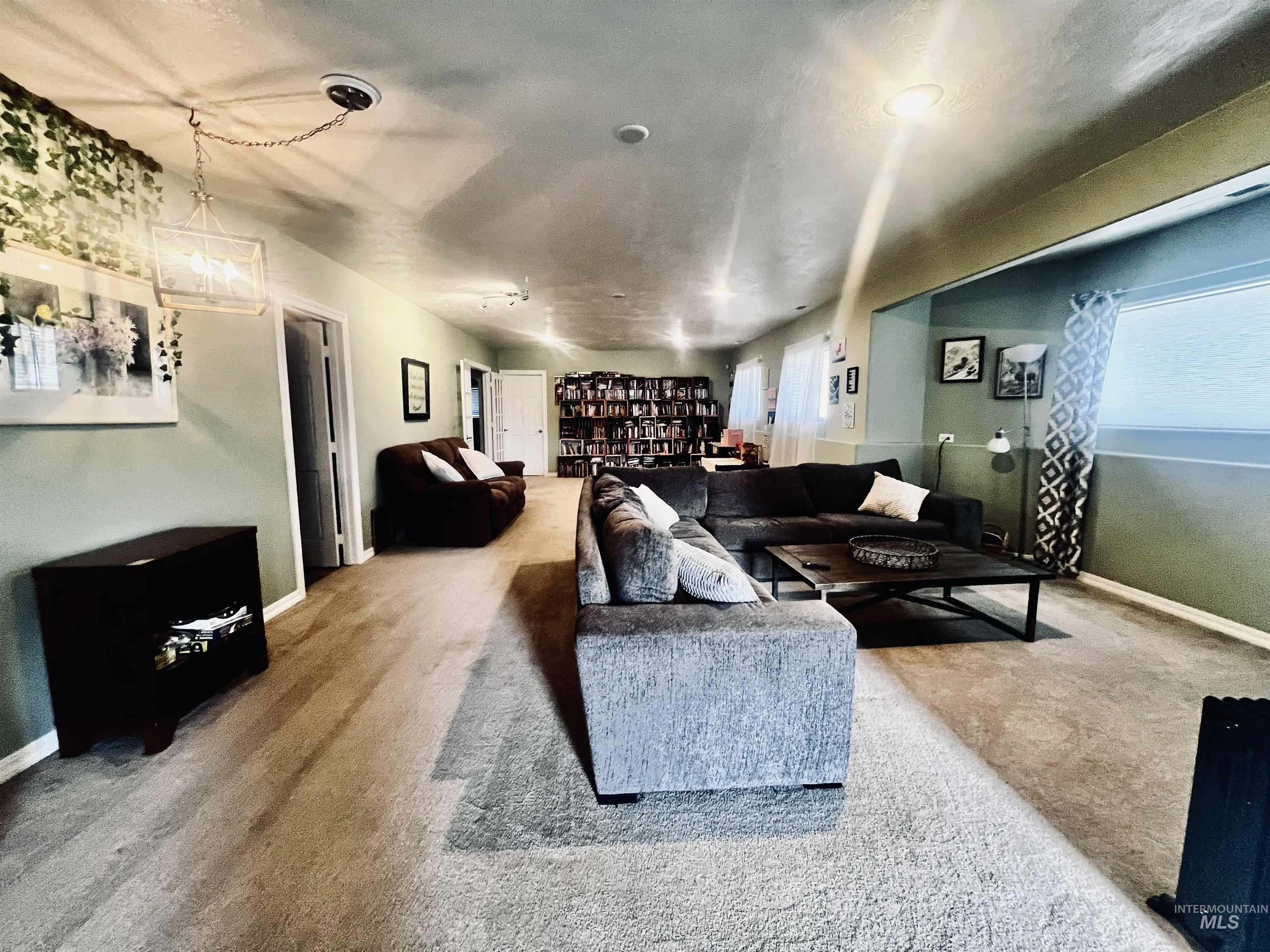 Carpeted living room with baseboards