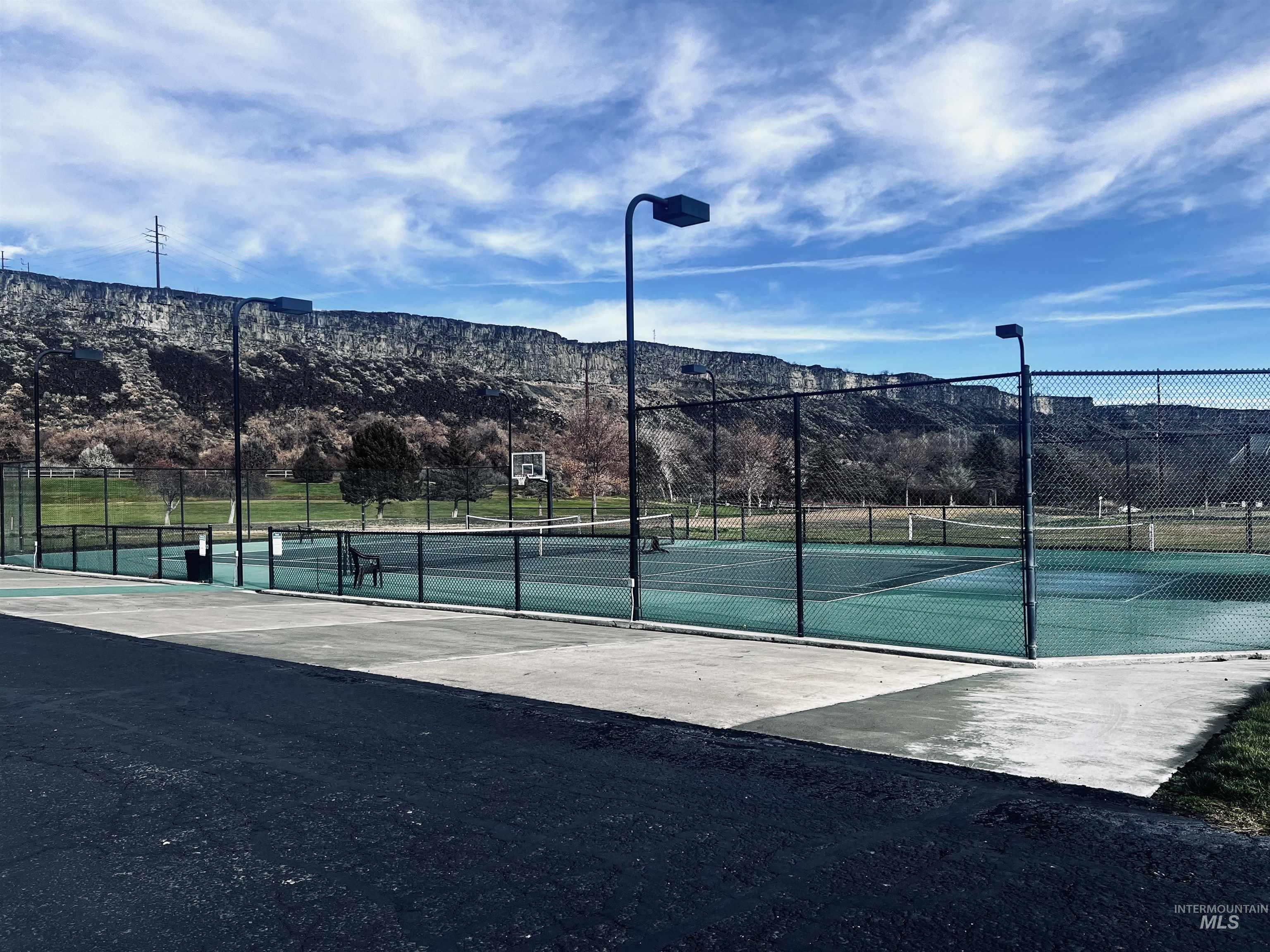 View of tennis court featuring a mountain view