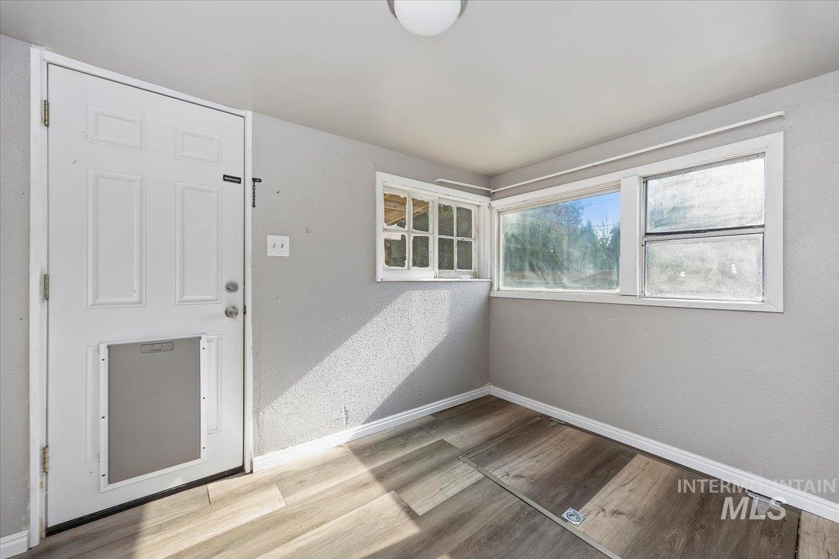 Foyer with a textured wall and light wood-type flooring
