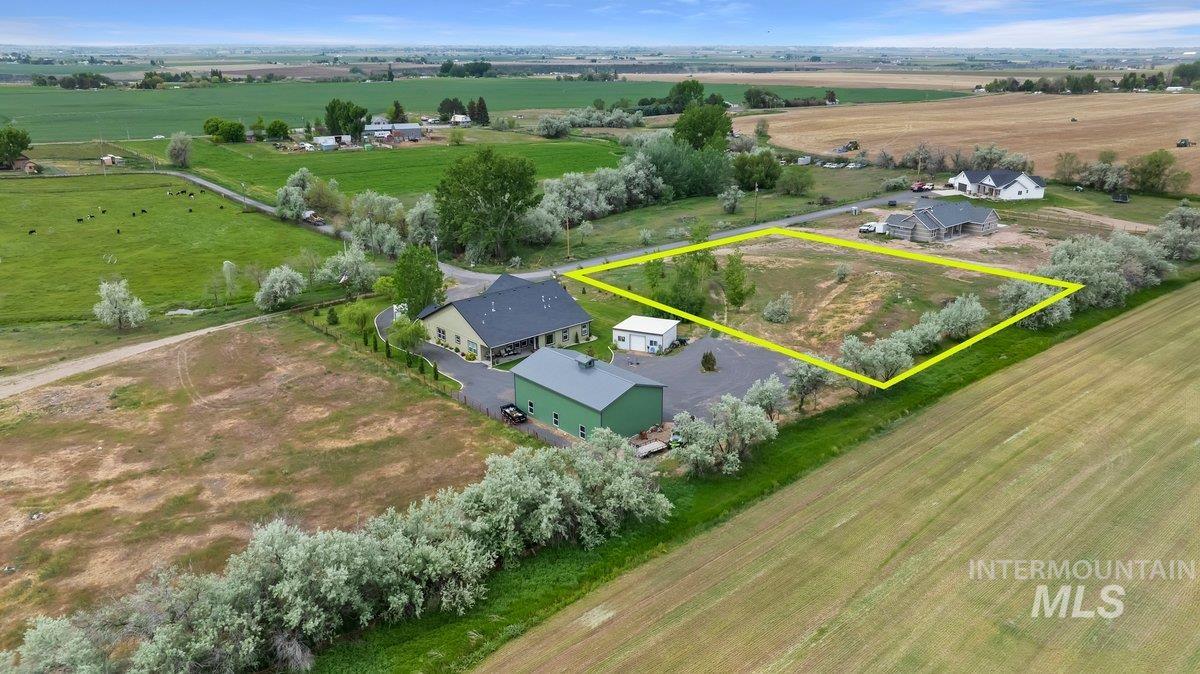 Aerial view of sparsely populated area with property parcel outlined