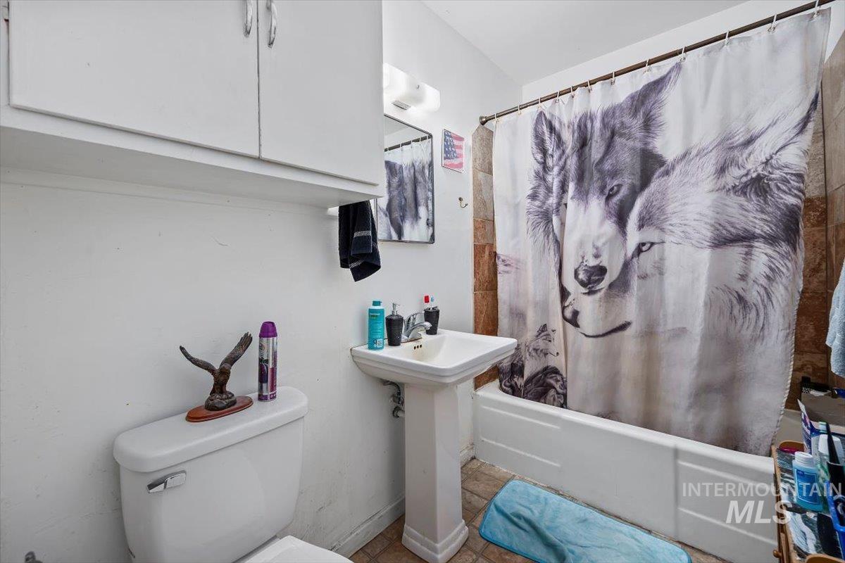 Bathroom with shower / bath combo and toilet