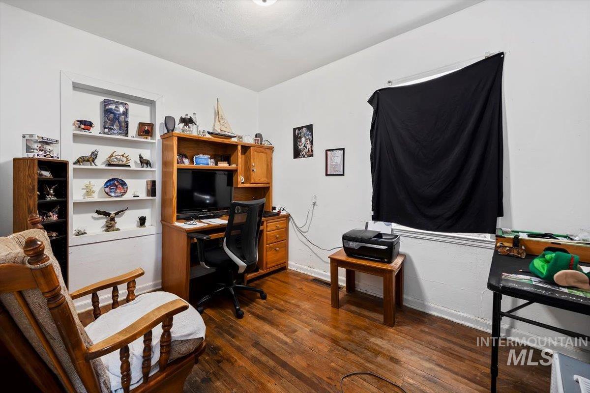 Office featuring dark wood finished floors and baseboards