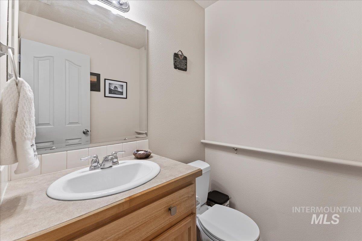 Bathroom featuring vanity and a textured wall
