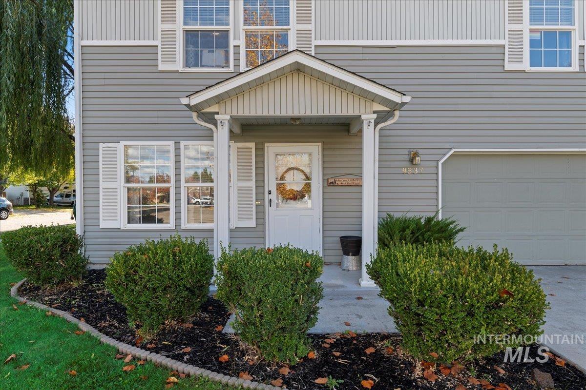 Doorway to property with an attached garage