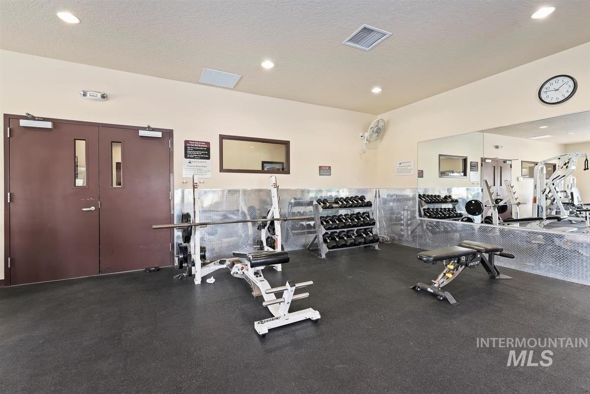 Workout area featuring a textured ceiling and recessed lighting