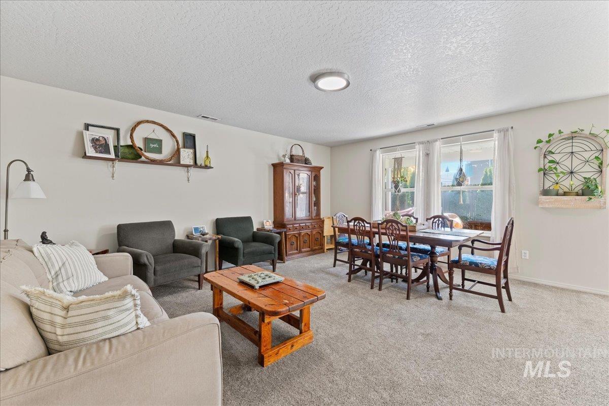 Carpeted living area with a textured ceiling