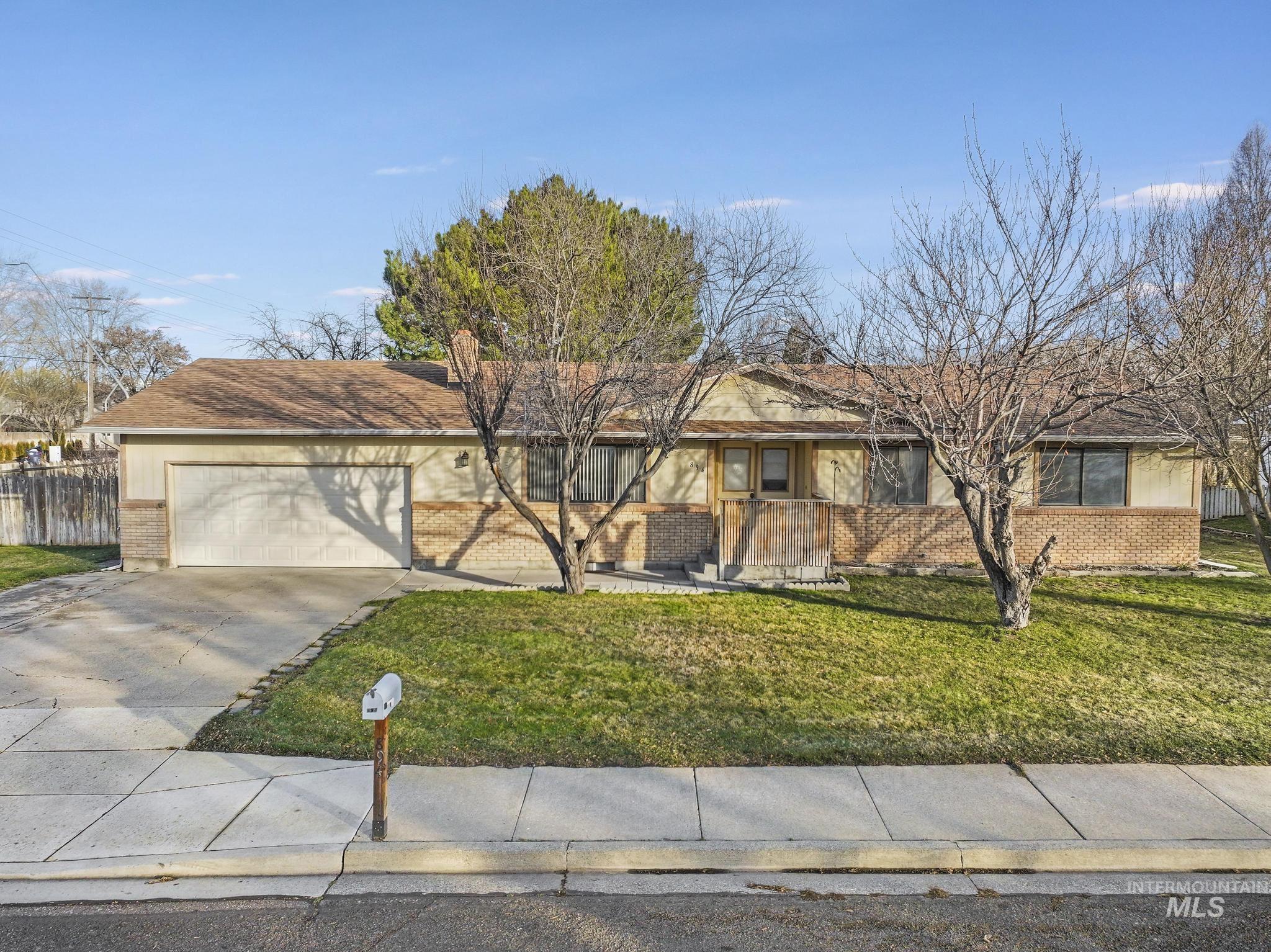 Ranch-style house featuring brick siding, concrete driveway, and a garage