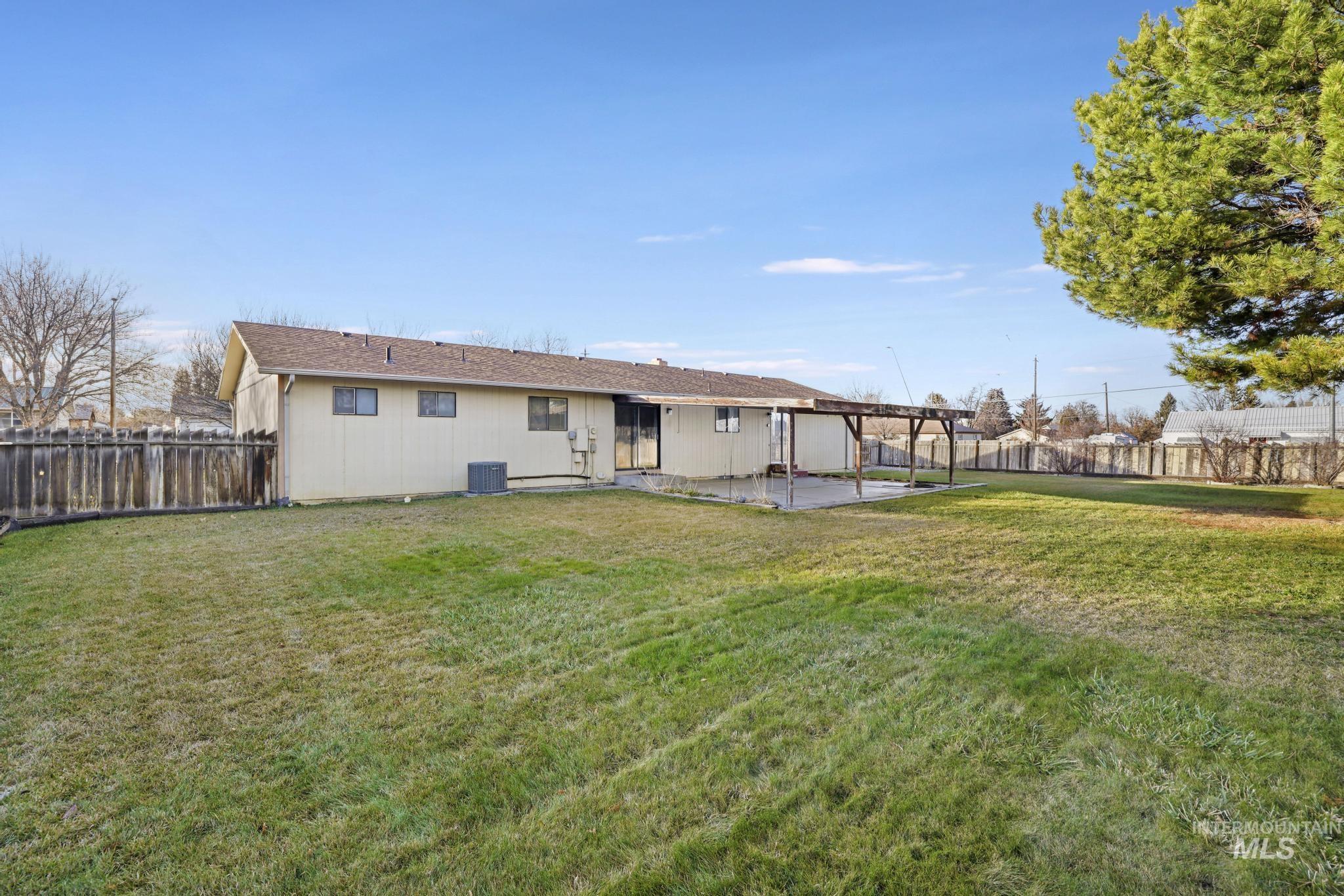 Rear view of property featuring a patio area, a fenced backyard, and a pergola