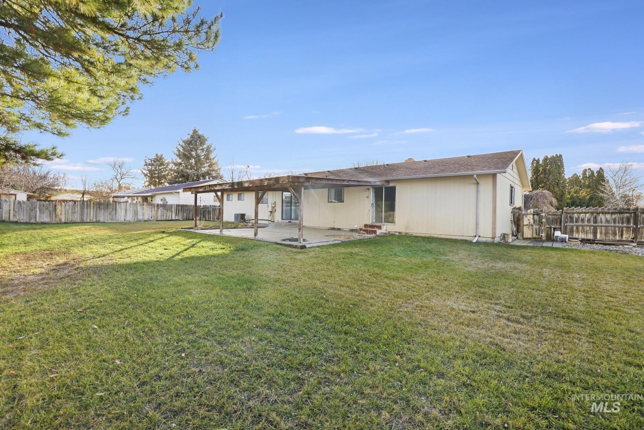 Back of house with a patio area and a fenced backyard