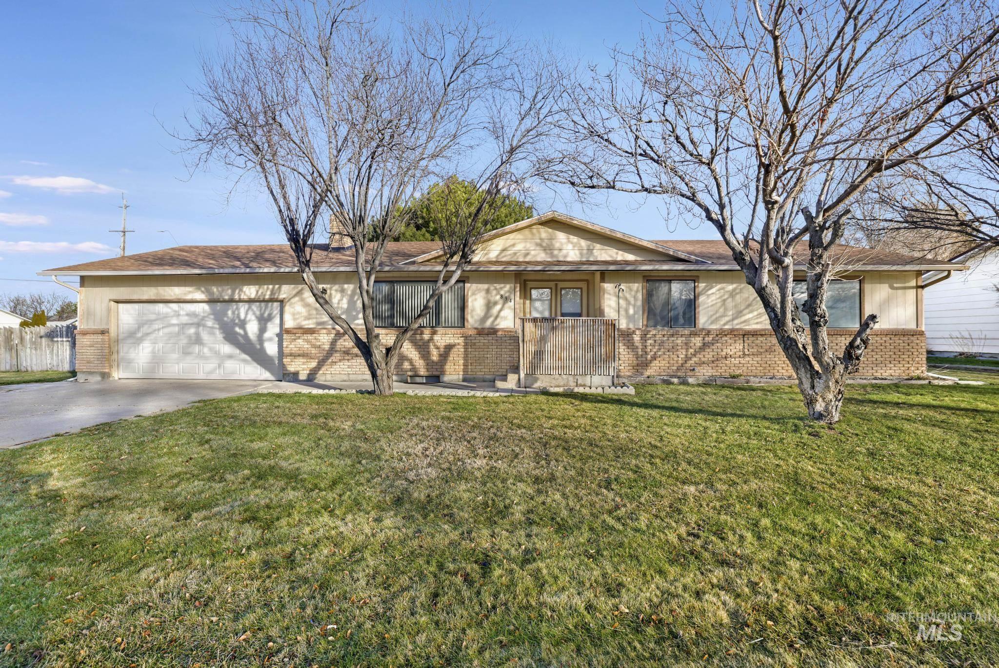 Single story home featuring brick siding, concrete driveway, a shingled roof, and a garage