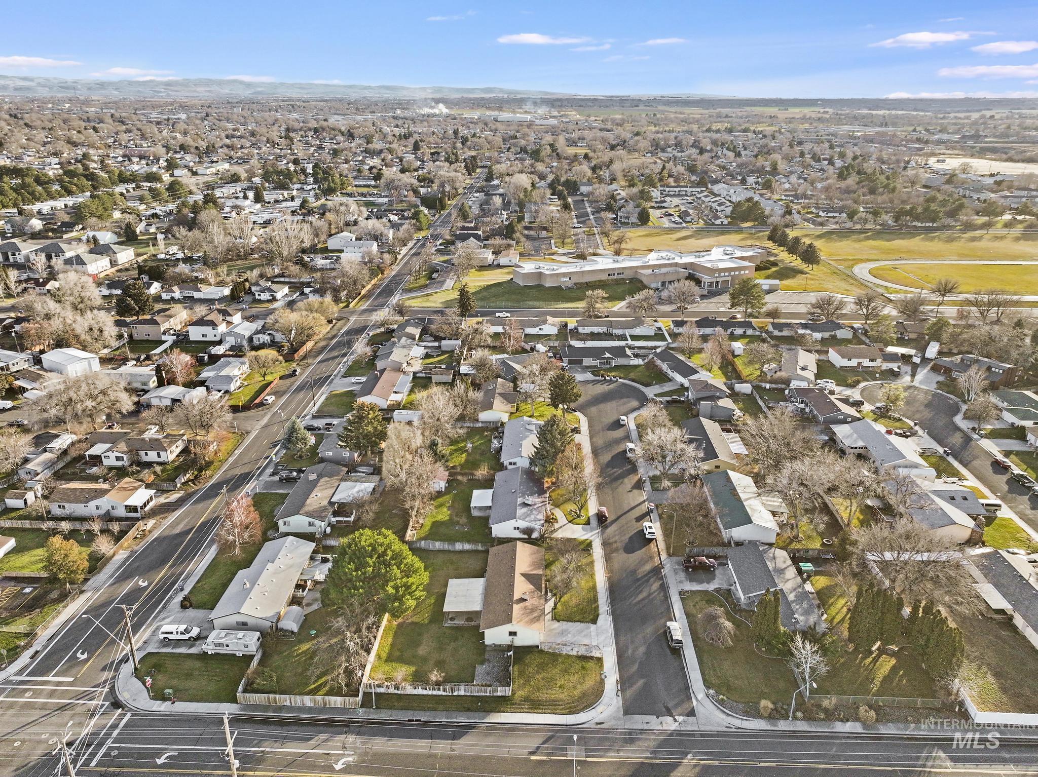 Aerial view of property's location featuring nearby suburban area