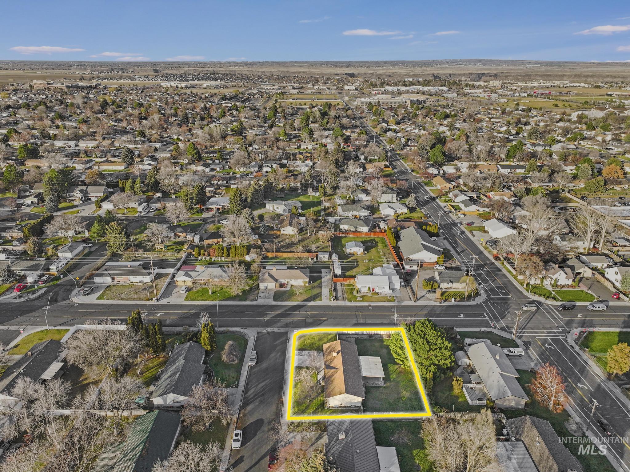 Aerial perspective of suburban area featuring property boundaries highlighted