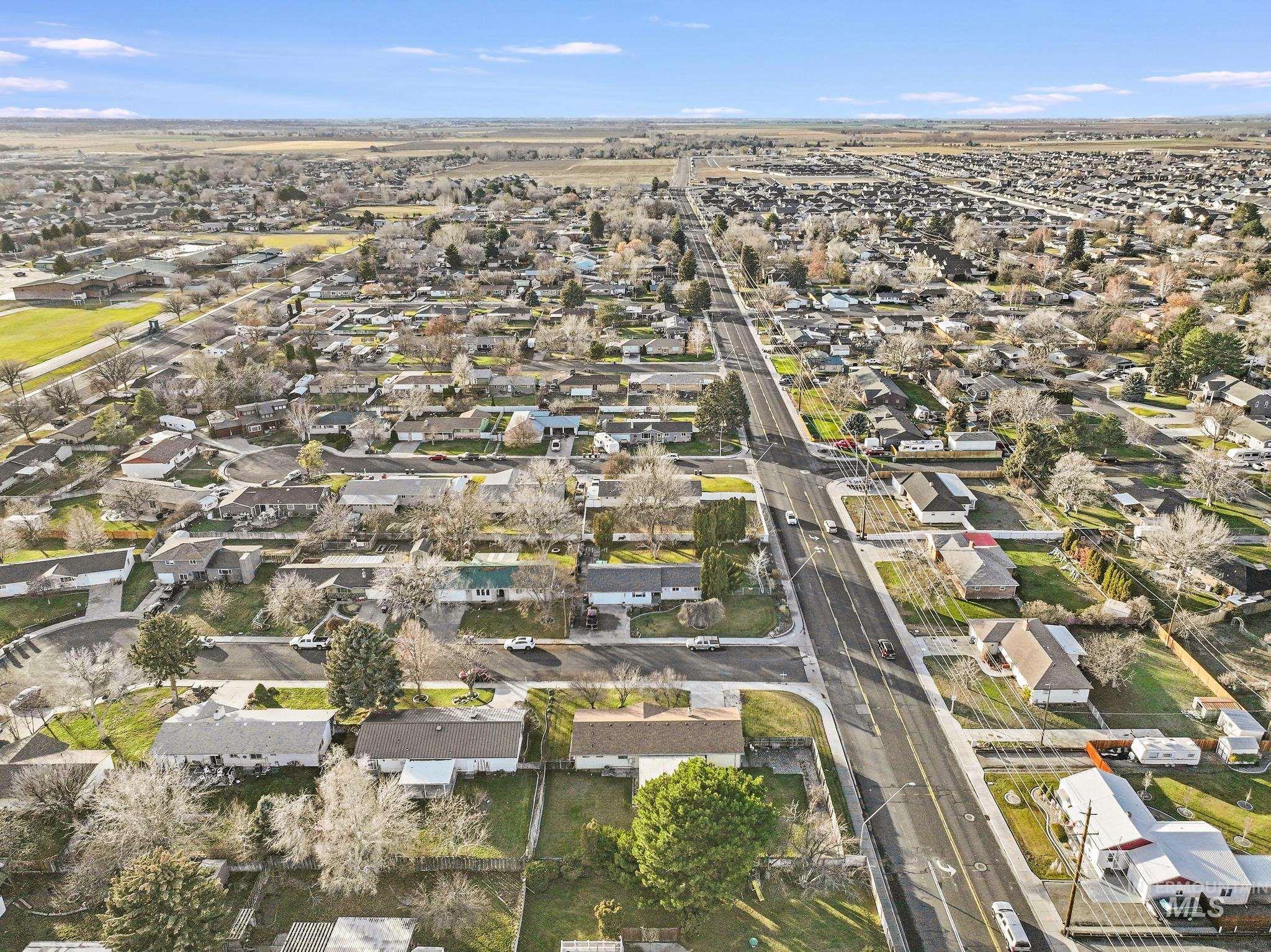 Aerial overview of property's location featuring nearby suburban area