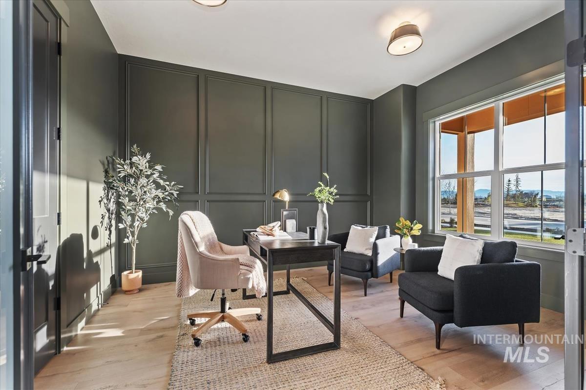 Home office featuring a decorative wall and light wood-type flooring