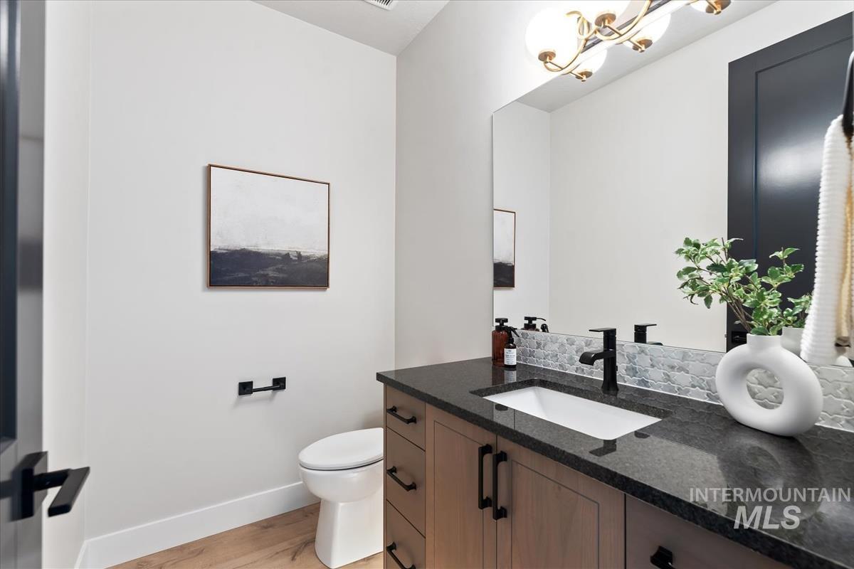 Half bathroom featuring vanity and light wood finished floors