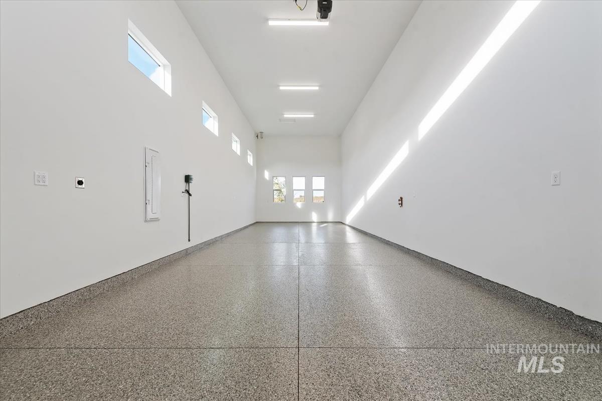 Spare room with a high ceiling and speckle patterned floor