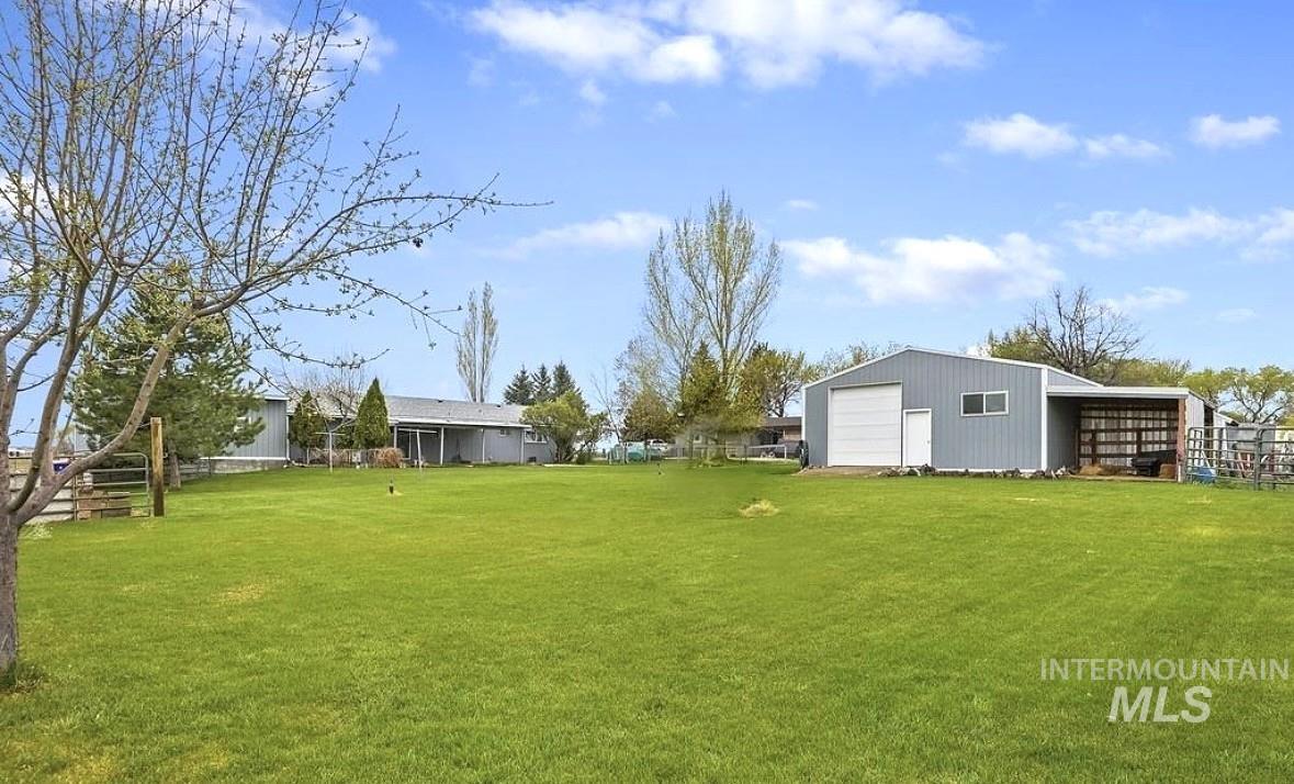 View of yard with an outbuilding and a detached garage