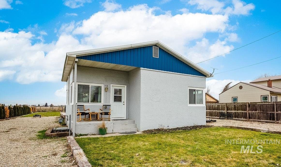 Back of property featuring a fenced backyard, stucco siding, and a patio area