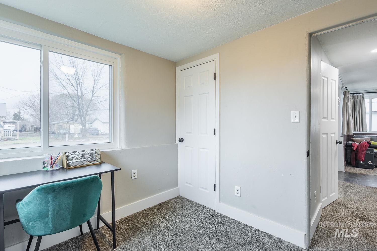 Carpeted office space with baseboards