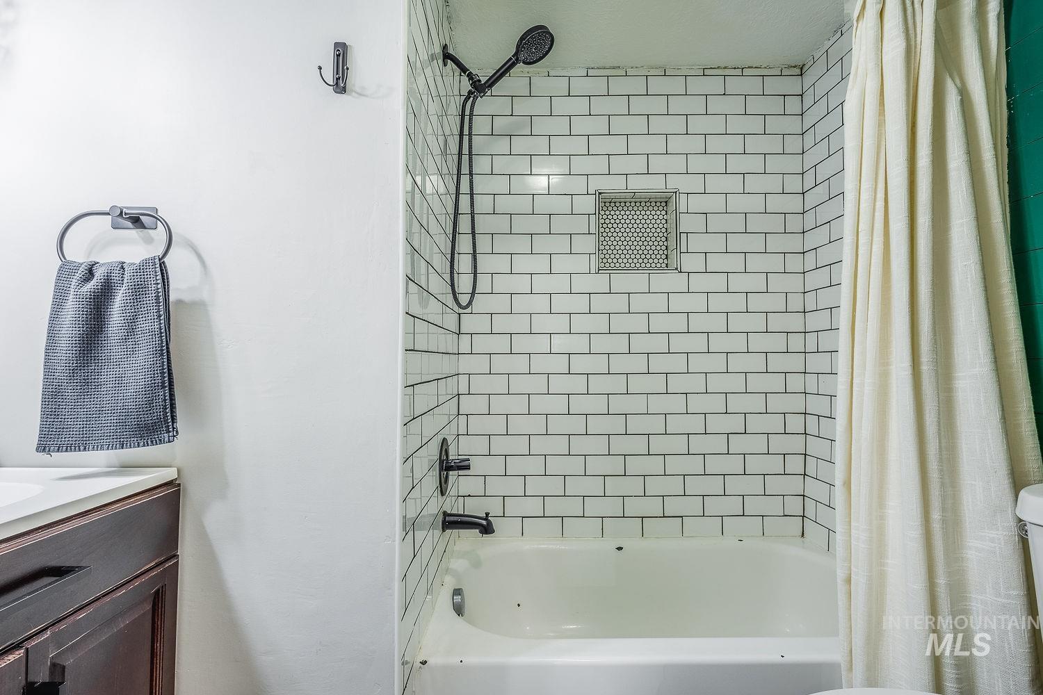 Bathroom with shower / bath combo and vanity