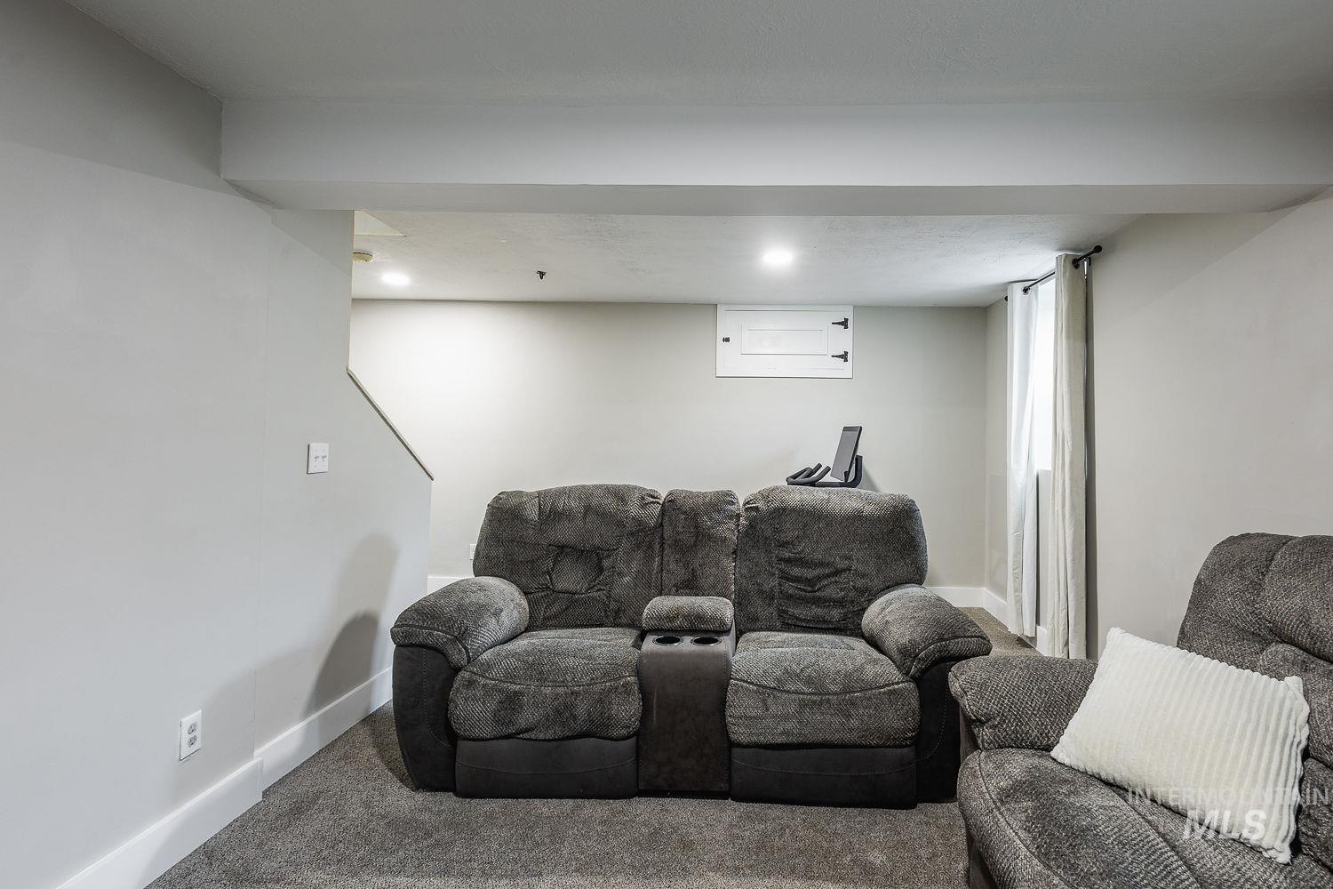 Living area with carpet flooring and recessed lighting