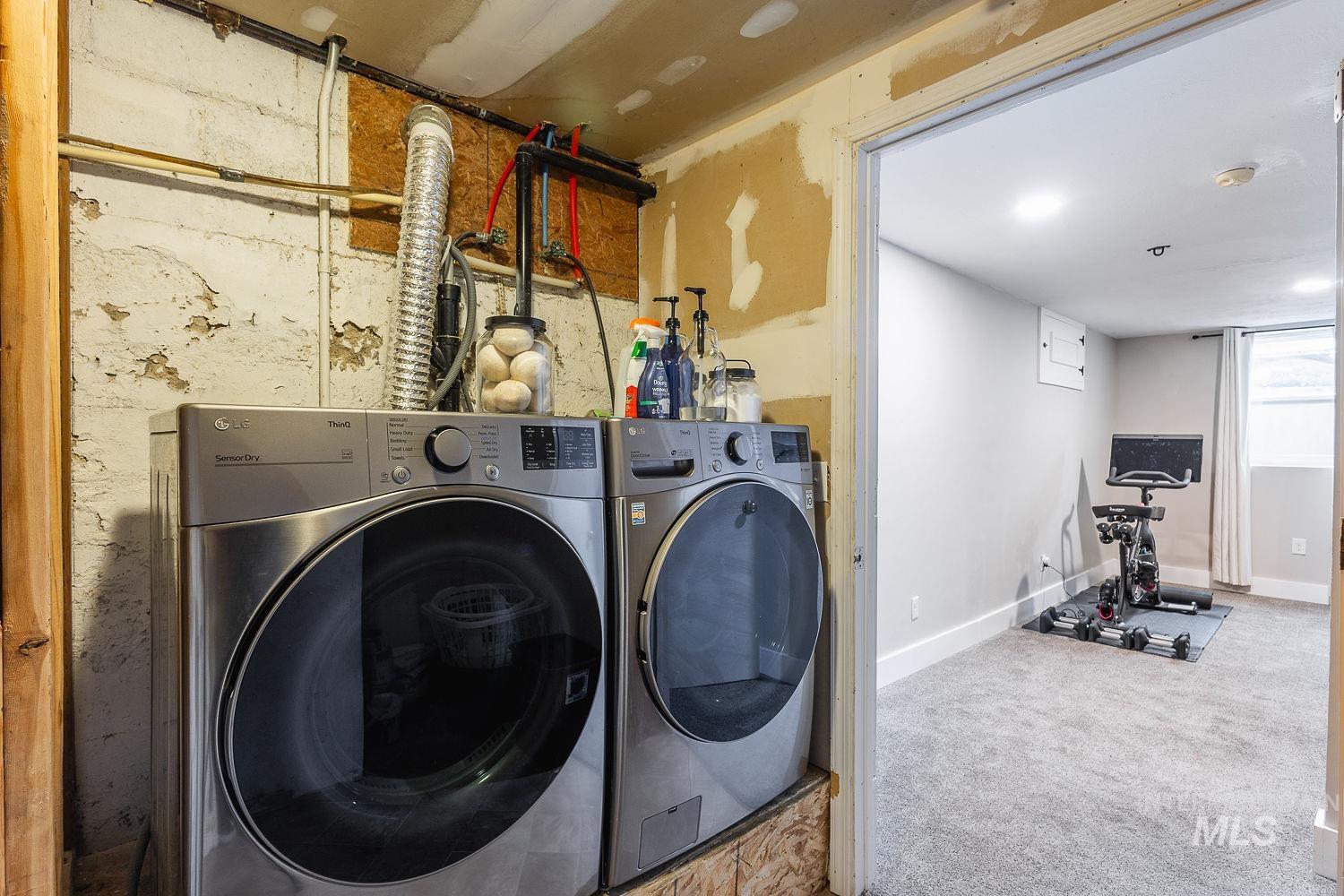 Washroom featuring carpet floors and washer and dryer