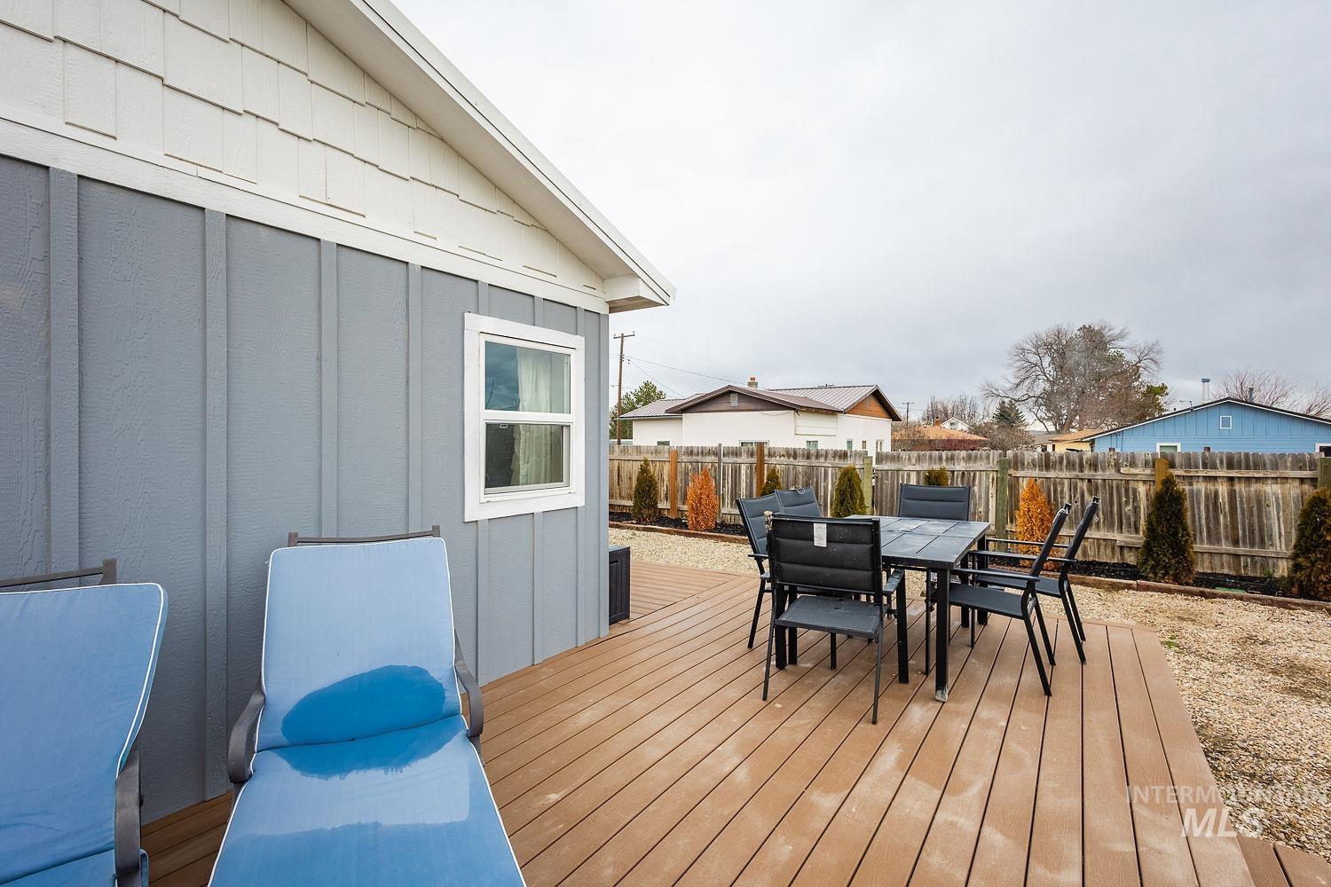 Deck with outdoor dining space and a fenced backyard