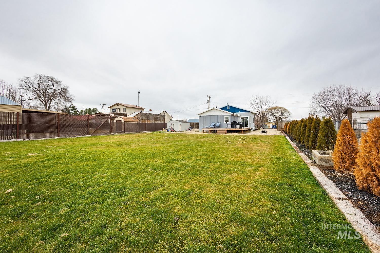 Fenced backyard with a deck