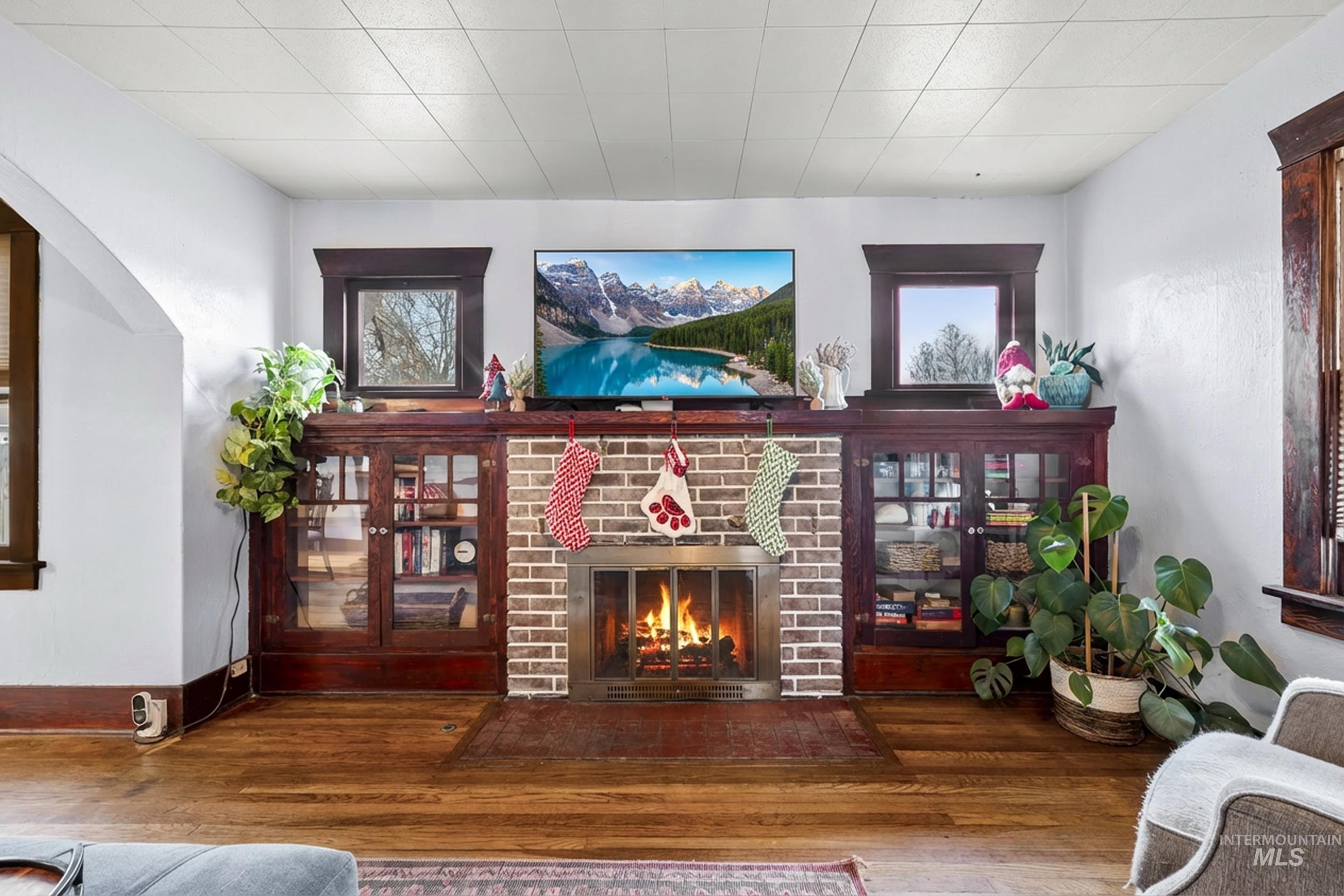 Living area featuring wood finished floors and a brick fireplace