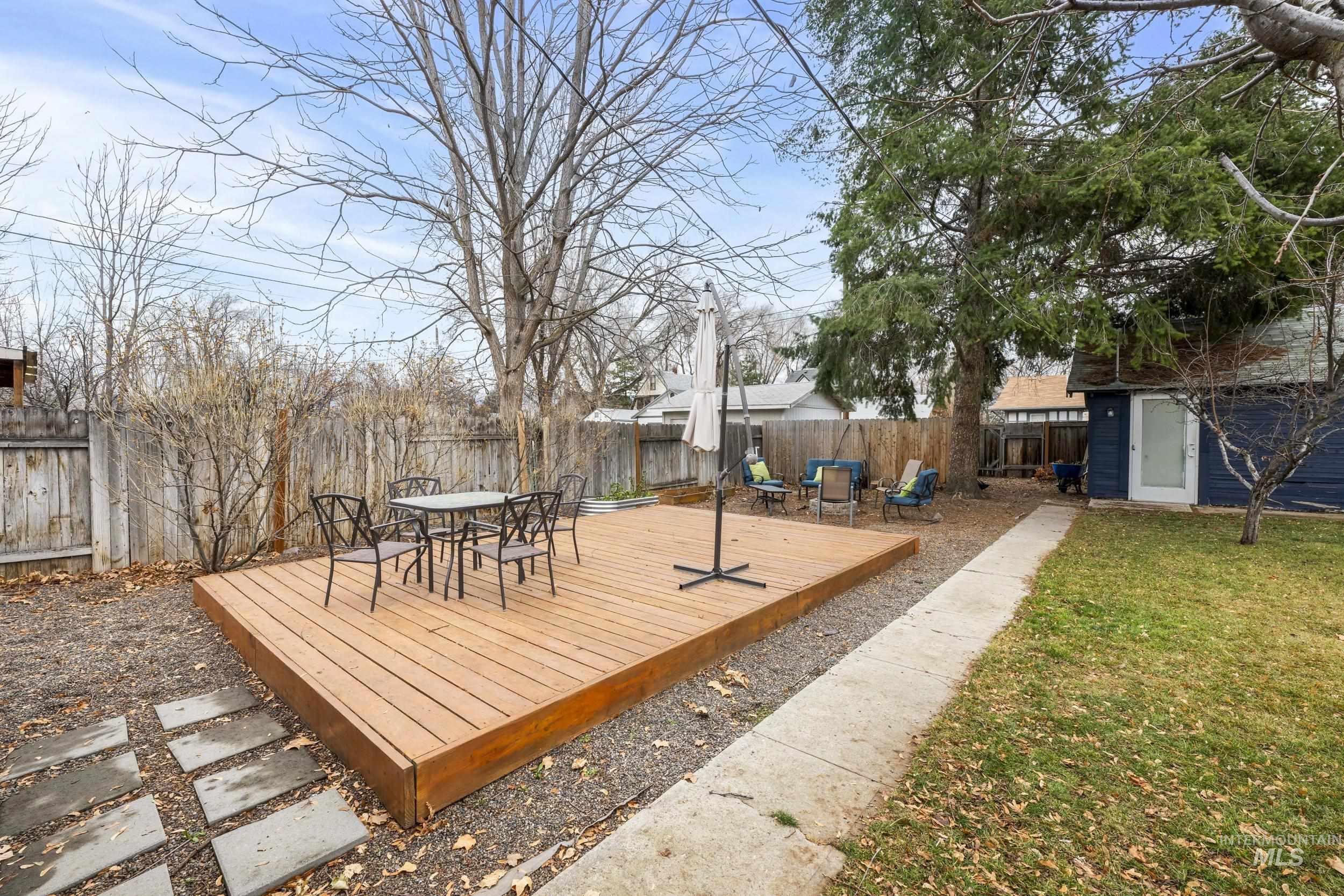 Deck with a fenced backyard and outdoor dining area