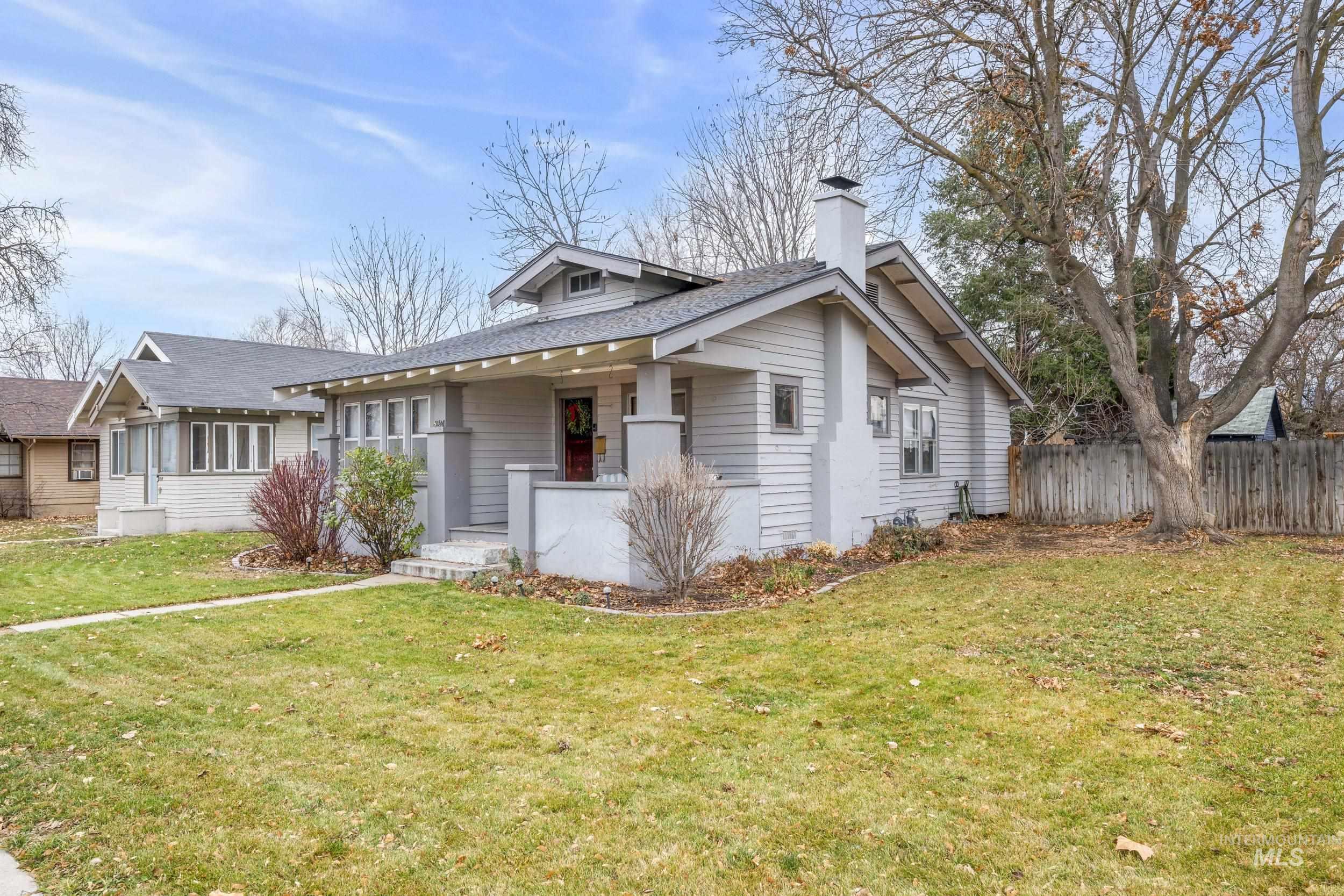 Bungalow-style home with a porch, a chimney, and roof with shingles