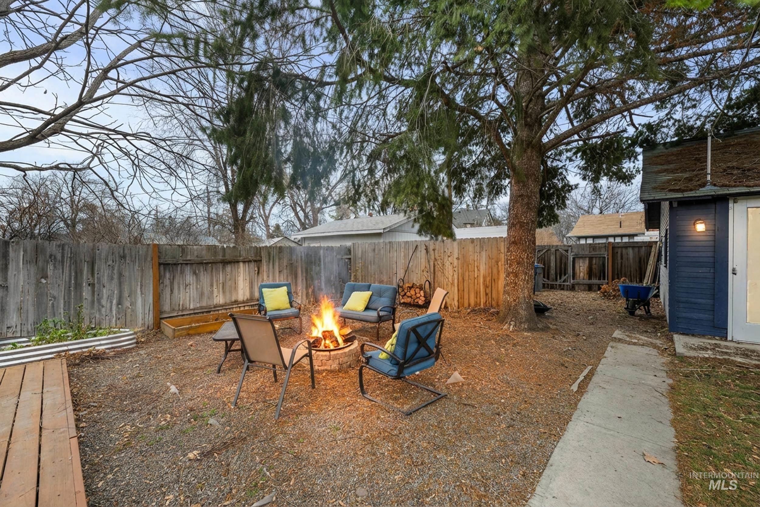 Fenced backyard with a fire pit