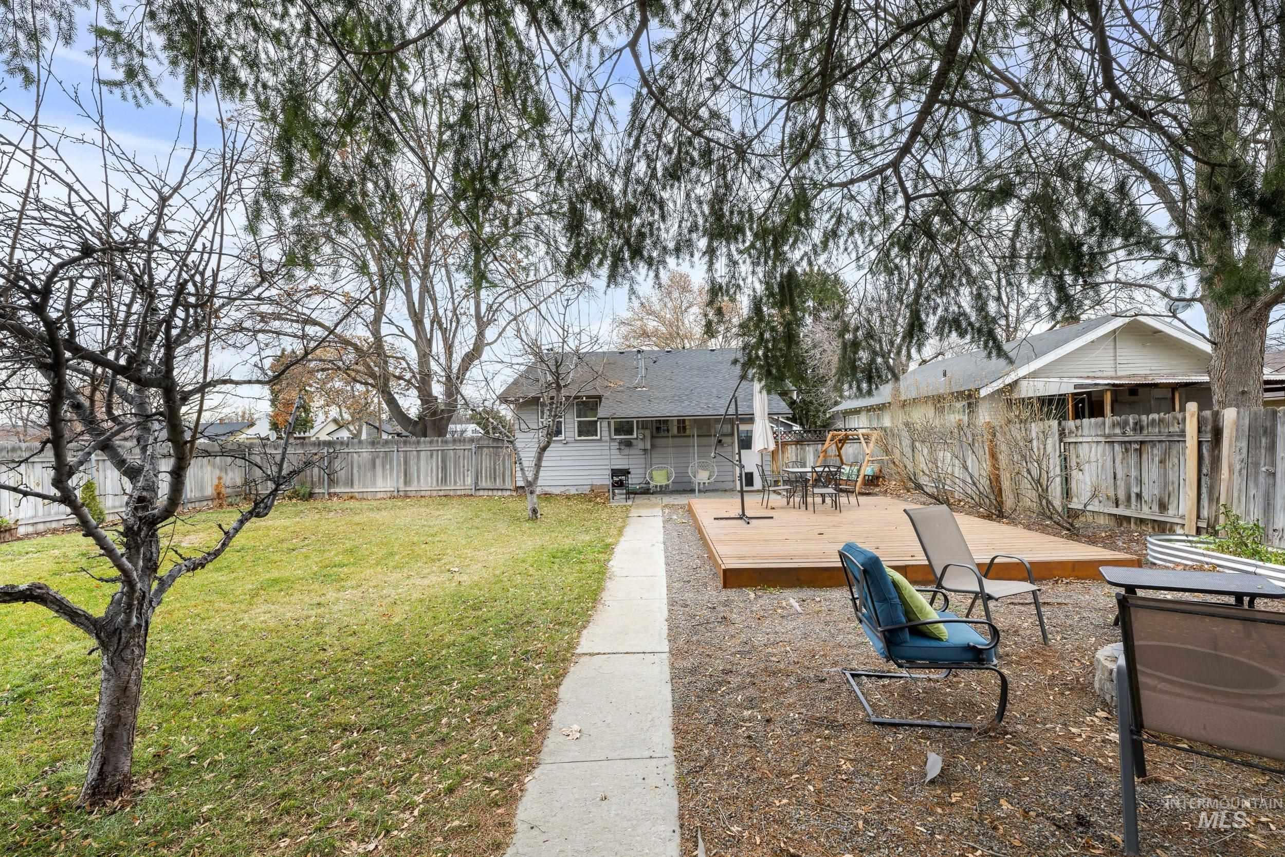 Fenced backyard featuring a wooden deck