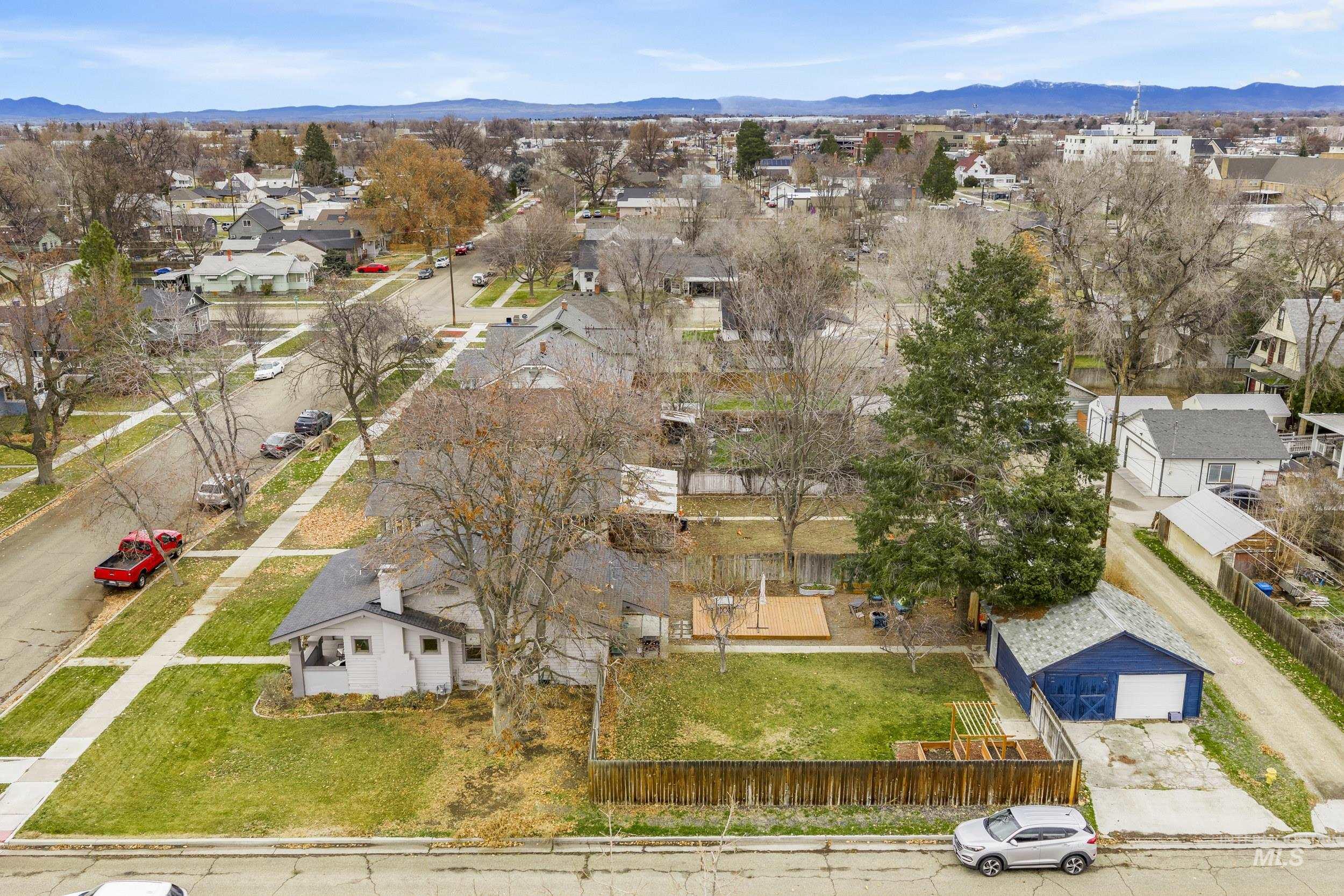 Aerial perspective of suburban area featuring a mountain backdrop